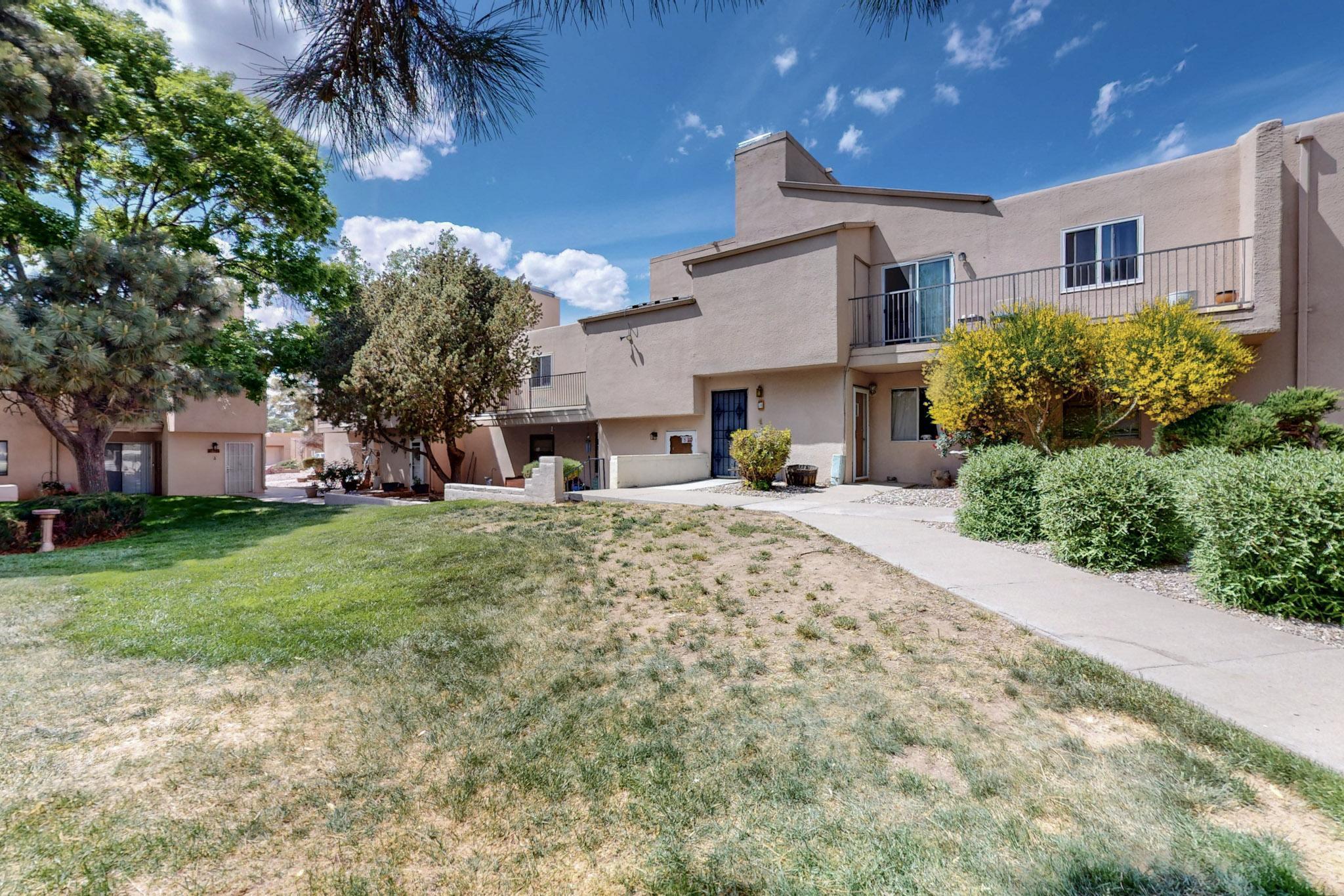 Discover comfort and convenience in this beautifully updated 2-bedroom, 2-bath condo in the desirable Sandia Plaza community. This move-in ready home features brand-refrigerator and dishwasher, stylish new flooring, fresh interior paint, and modern light fixtures throughout. Soaring vaulted ceilings with skylights fill the open living space with natural light.Enjoy serene views of the community pool from your balcony and take advantage of exceptional amenities including a clubhouse, outdoor pool, and landscaped common areas. Ideally situated in the Northeast Heights, you're just minutes from top-rated restaurants, grocery stores, and gyms. HOA fees include water, sewer and trash, common area and exterior maintenance, giving you peace of mind and low-maintenance living.  Call today!