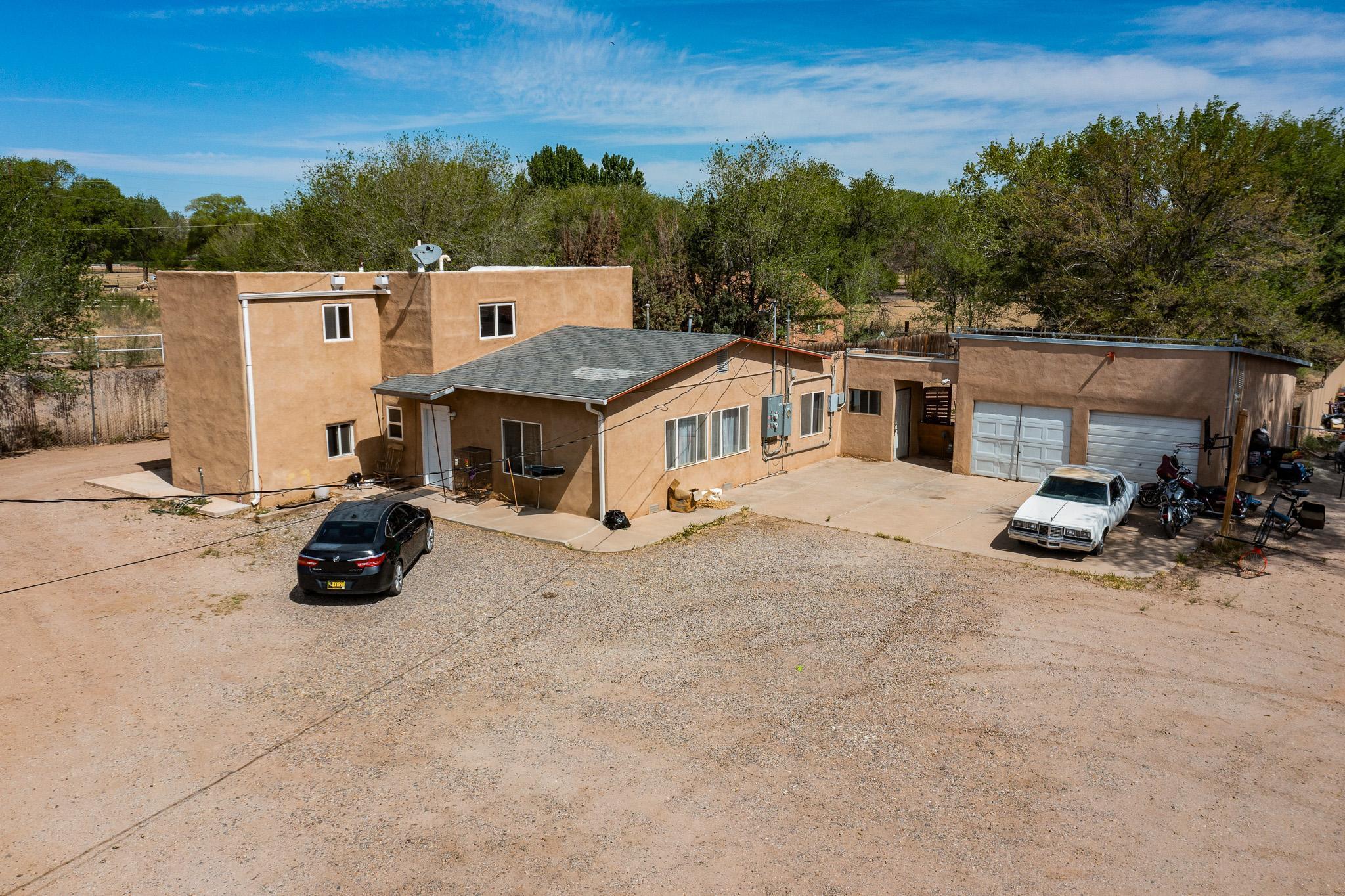 Welcome home to Valley Farms. This property is comprised of 3 homes with land & 1 parcel of vacant land. The main home has 4 (possibly 5) bedrooms, 3-baths, refrigerated air, was built in 1950 & has 2709 SqFt.  It has been updated w/ fresh paint, some new flooring, refrigerated air & it includes .732 acres w/ water, sewer, gas & electric connected. Other parcels included are #101105114414330320 with 1 bed, 1 bath casita and .652 acres, #101105117414330321 with .709 acres of vacant land & #101105118714330326 with 2 bed, 1 bath mobile home & 1.052 acres. Seller will entertain selling parcels separately. Cash or Owner Financing only. Come check out this cool South Valley compound today!