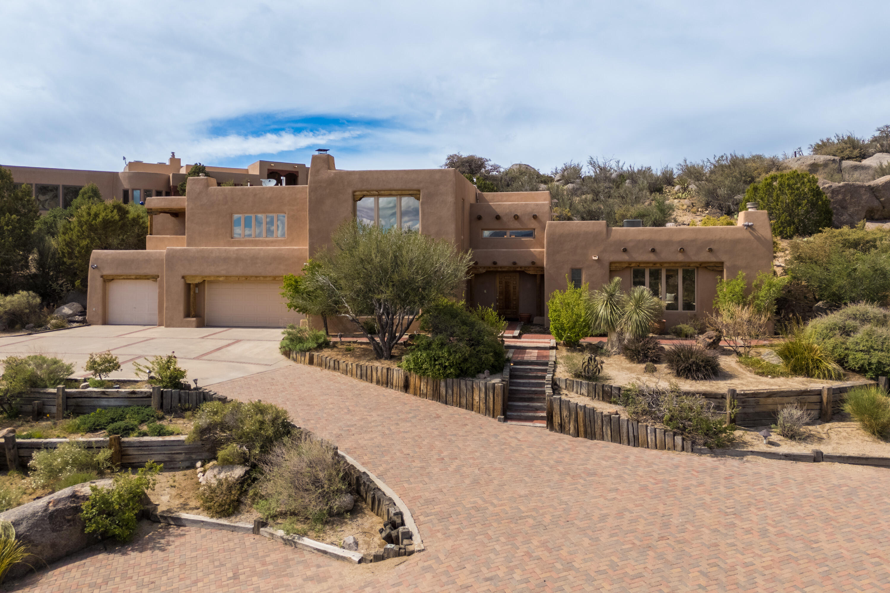 Absolutely STUNNING VIEWS offered from virtually every room of this SANDIA HEIGHTS area custom home. This 4bdrm/4bath home is light and bright throughout  and offers 2 living areas with a formal dining room which makes it great for entertaining! Island kitchen with large breakfast area. Fabulous primary suite with amazing VIEWS and updated bath. Also included you will find a teen quarters/in-law suite, breakfast nook, Pella windows, and a 3 car garage with plenty of extra room for storage. Outdoor living at its finest offering 2 open patios, and an open deck all of which offer views of  either the Mountains or the city! You can watch the tram come up and down the mountain, or step outside and enjoy the close proximity to hiking and biking trails.