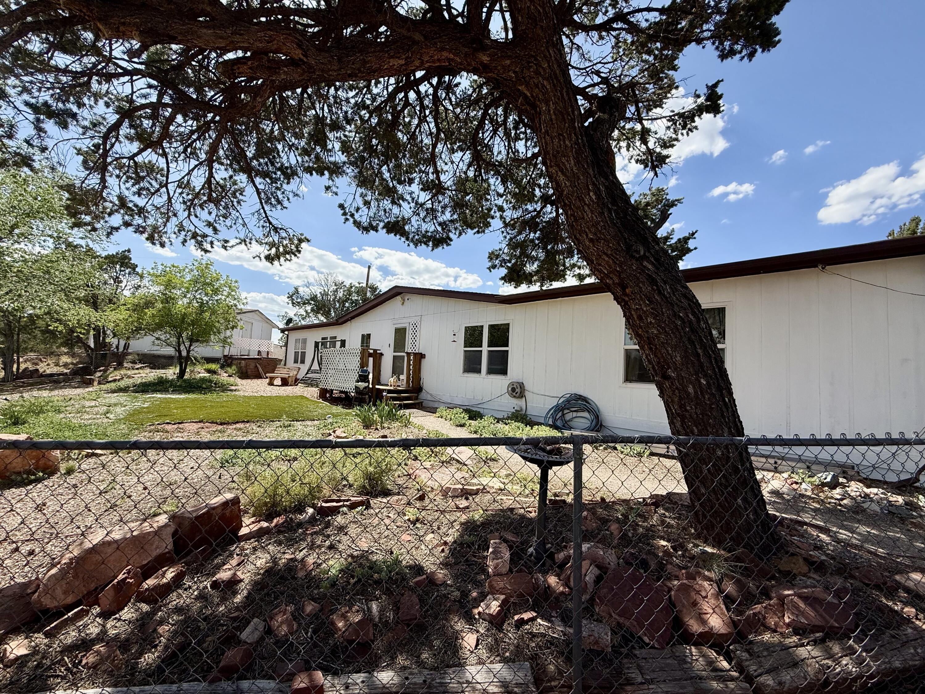 Welcome to this charming 3-bedroom, 2-bathroom home situated on a spacious 2.11-acre lot in the picturesque village of Tijeras. This property is an ideal opportunity for investors or DIY enthusiasts looking for a fixer-upper or a potential flip.The home features a generous layout with plenty of room for customization. One of the standout features is the large garage/shop, perfect for those who need additional storage or workspace. Additionally, there is a partially finished Casita that offers even more potential for guests or rental income.Please note that several repairs are currently underway to enhance the property, and more photos will be available soon to showcase the updates. Don't miss out on the chance to make this property your own! Whether you're looking to