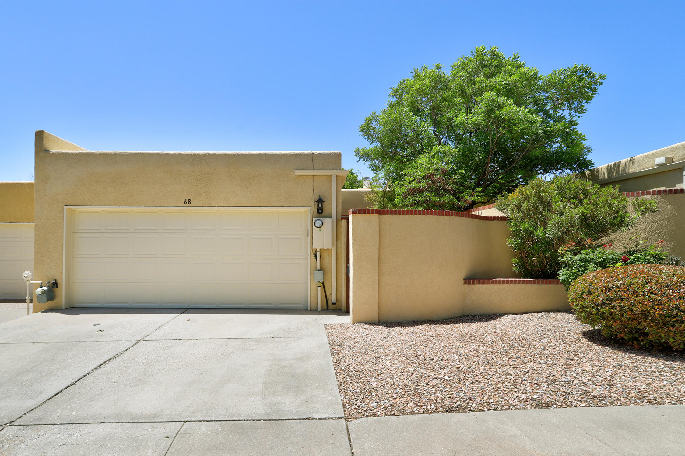Nothing else on the market compares to this pristine, expensively remodeled one level townhome discovered in a well-manicured community at the base of the Sandia Mountain. Definitely a WOW experience! Enter the private courtyard and you'll be greeted by fragrant roses; cross the threshold and you'll be electrified with excitement as you absorb the priceless peaceful energy...