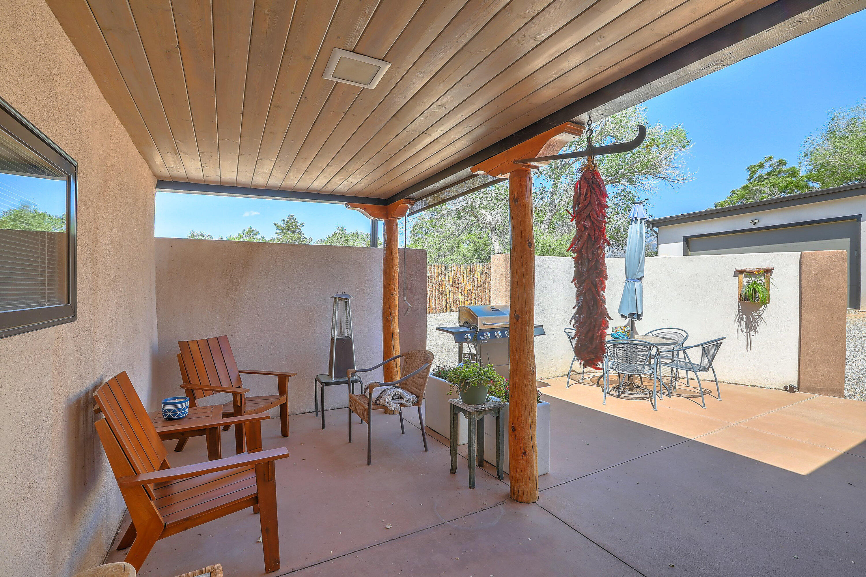 Rare opportunity! Beautifully updated adobe gem with detached oversized garage  and connected studio, office or storage space. This unique treasure is tucked away in one  of the most sought-after neighborhoods in ABQ.  Sitting on a gorgeous, private lot filled with character and charm, the property offers a serene blend of historic warmth and modern convenience.Inside, original hardwood floors grace the sun-drenched living room, radiating timeless elegance. The home has been thoughtfully updated while preserving its southwestern soul, including the addition of refrigerated air for year-round comfort.Meticulous is care evident throughout this beautiful home!! PAID OFF SOLAR!