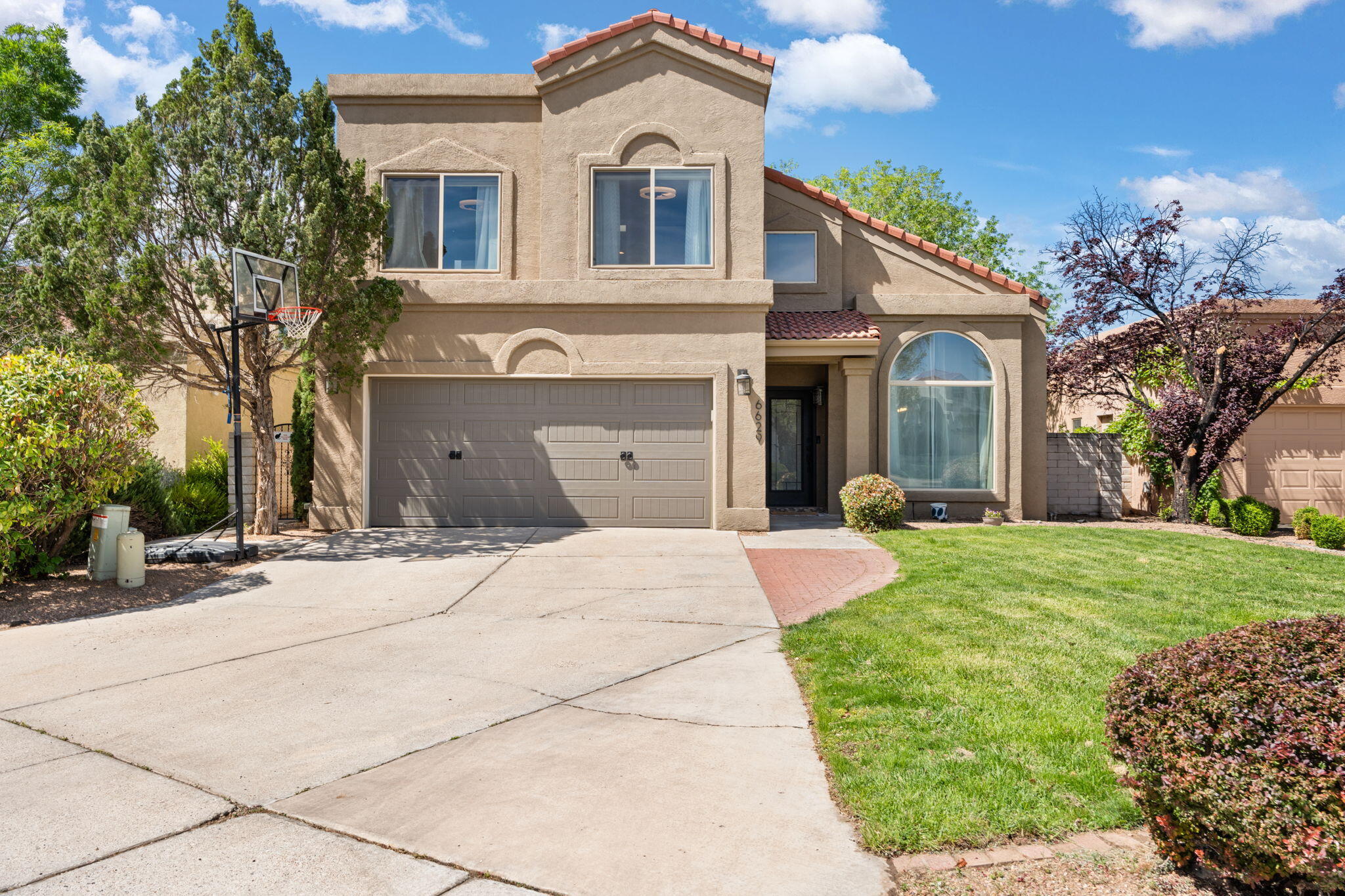 Beautiful 2-story home in the gated Tanoan Community. This 3 bed, 3 bath home with a bright, open kitchen and spacious living areas. Fully remodeled with 2 living areas, a loft, and a great floor plan. Enjoy the private, walled backyard with an open patio & gazebo--great for relaxing or entertaining. Lush front and back lawns are maintained with an auto sprinkler and bubble drip system for easy care and year-round curb appeal. Located close to shopping, dining, and top-rated schools! You do not want to miss out on seeing this Tanoan beauty!