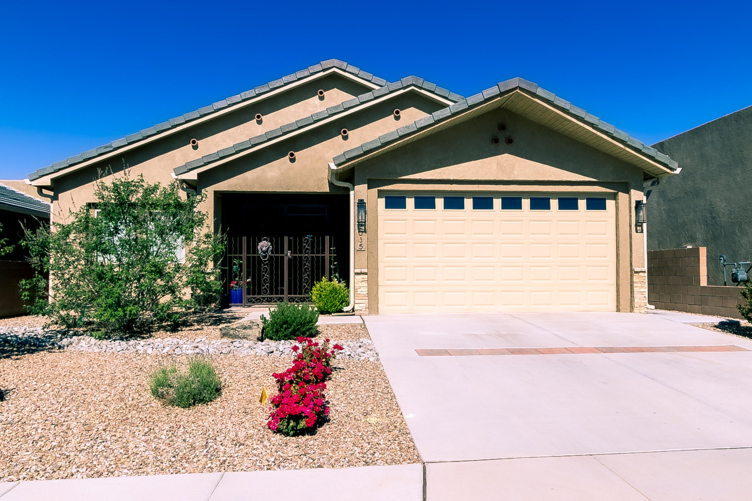Peace & quiet & a custom Paul Allen 1-level home that backs to open space in Volterra! Better than new condition! Constructed to emerald-level green standards for elevated energy efficiency. Enclosed gated entry opens to great room w/gas FP + dining area. Exceptional kitchen w/granite countertops & custom cabinetry. Tiled floors throughout; no carpet. Whole house filtration system. Pendant lamps, decorative ceiling fans, recessed lighting & Legrand switches. Primary suite w/big WIC + ensuite bath w/curbless shower & dbl vanity + adjacent 3rd bdrm/private retreat.  Extra large guest bedroom w/sitting room & bath adjacent. Backyard finds extended cov patio, auto watering system & low-maintenance turf. Oversized 2 CG. ION solar panels included.