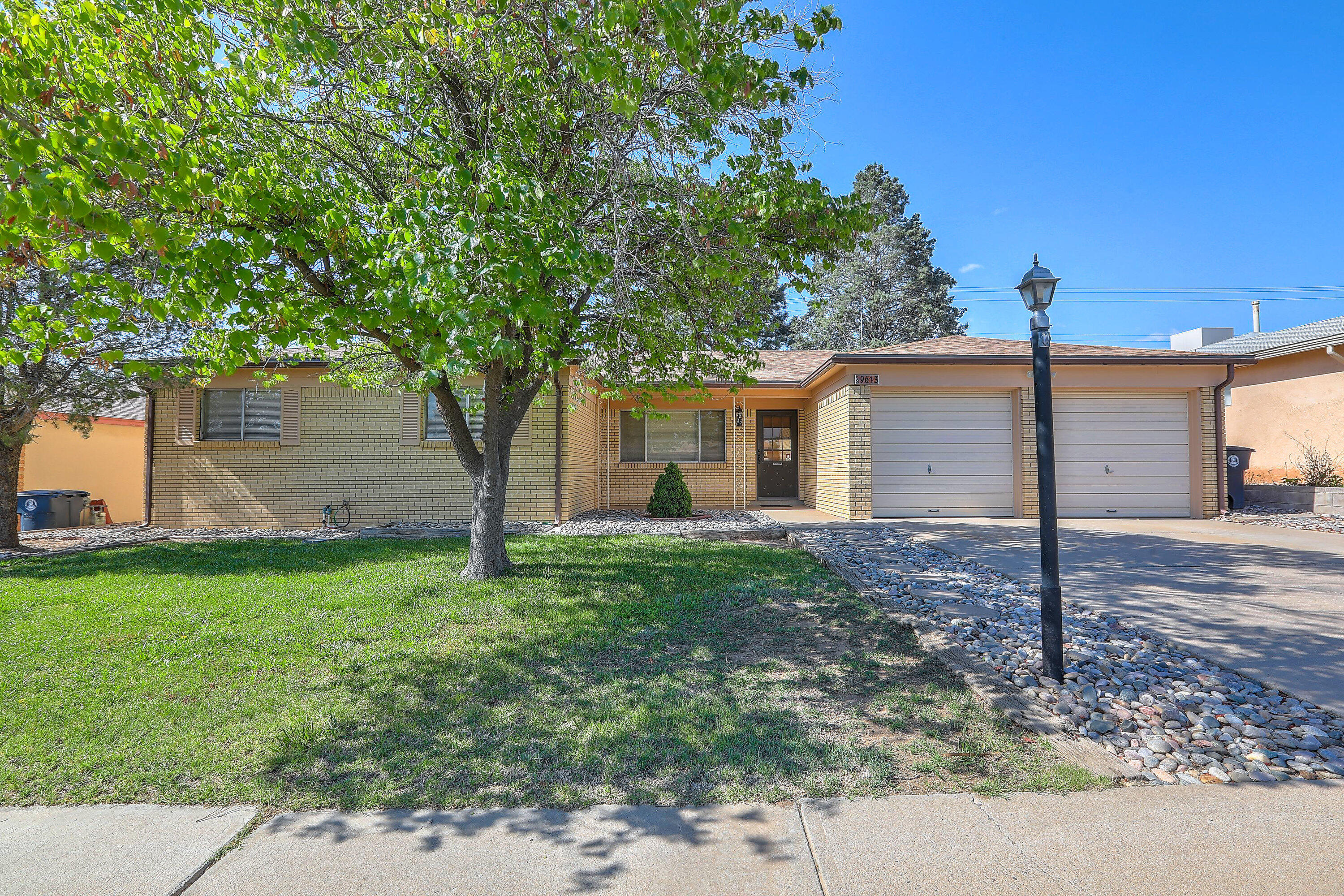 Welcome to 9613 Gutierrez NE. This home has Four bedrooms and 2 living rooms. Two baths and a large laundry room make living life a bit easier.  This home has a two-car garage and an abundance of storage space.Well maintained home with a beautiful brick fireplace and views of the mountains from your back patio. Don't miss this great home!