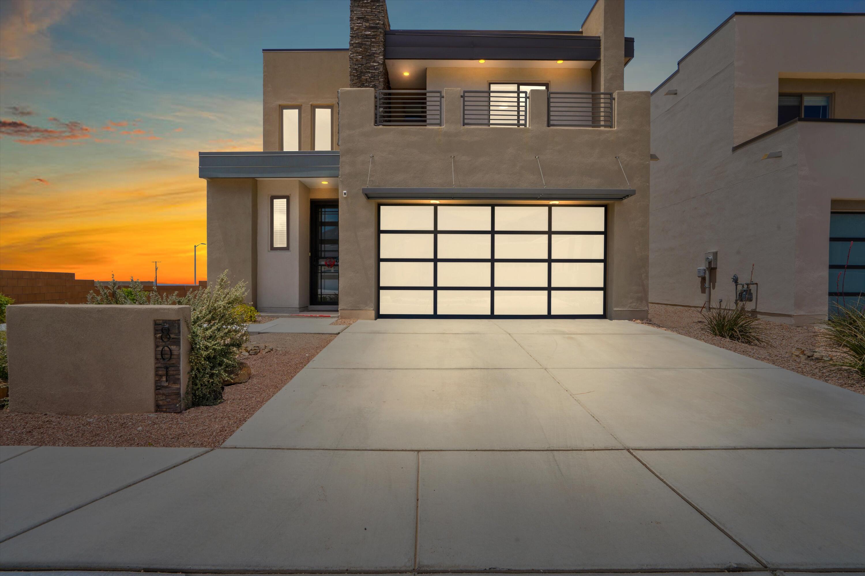 Step inside this stunning, 5-year-young contemporary home on a premium lot in Sandia Heights. Enjoy breathtaking views of the Sandias and city lights from nearly every room. With 4 spacious bedrooms--including both upstairs and downstairs primary suites--3.5 baths, and 2,700 sq ft of beautifully designed living space, this home offers both comfort and style. Warm tones and sleek modern finishes create a sophisticated yet inviting feel. Relax on the private balcony and take in the scenery--this home is a true retreat.