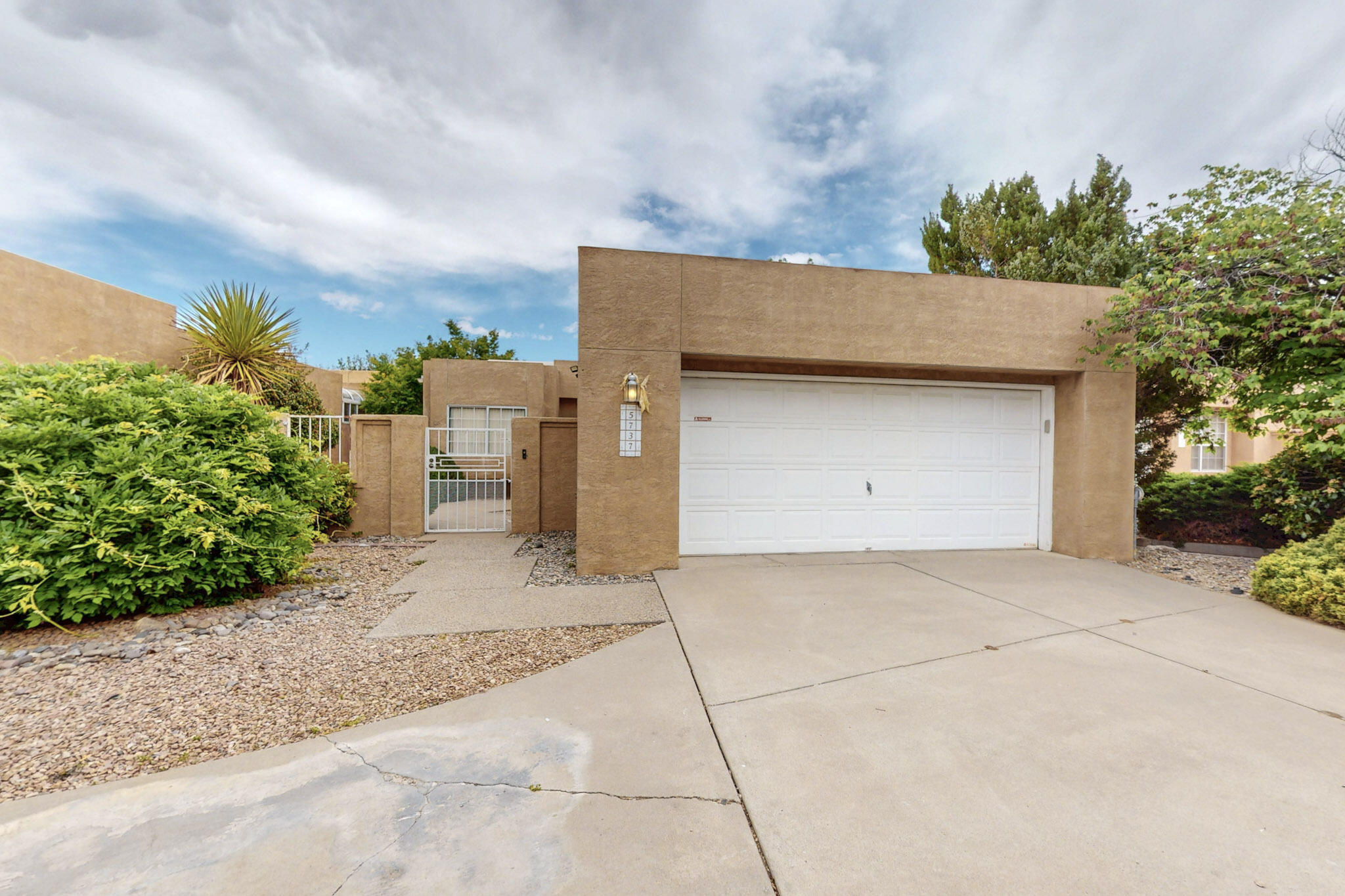 Exquisitely updated luxury patio home in one of the NE Heights' most desirable communities. This single-level stunner offers soaring ceilings, elegant tile flooring, and a bright, open layout perfect for entertaining. The chef's kitchen features granite countertops and stainless appliances. Retreat to the serene owner's suite with a spa-style bath and medical-grade sauna. Major upgrades include new TPO roof, HVAC, refrigerated air, windows, and carpet. Enjoy a private, lushly landscaped courtyard just minutes from Sandia trails.