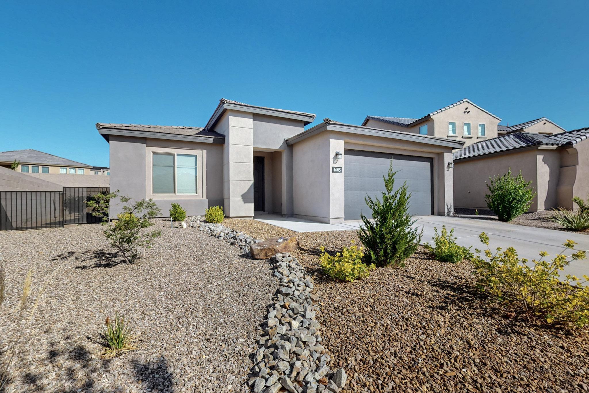 Located in a gated Volcano Cliffs community, this 3-bedroom, 2-bath single-story home includes a dedicated office that can serve as a 4th bedroom. Built in 2021, it offers 2,054 sq ft of open living space with high ceilings, wood-look tile in main areas, and carpet in bedrooms. The kitchen features quartz counters, stainless appliances, and a large island perfect for entertaining. The primary suite includes double sinks, a tiled shower, and a spacious walk-in closet. Enjoy the landscaped backyard with a covered patio and a beautiful gazebo. Refrigerated air, 2.5 car garage, and low-maintenance yard. We love working with Buyer Brokers--reach out to your favorite Realtor and see it today!