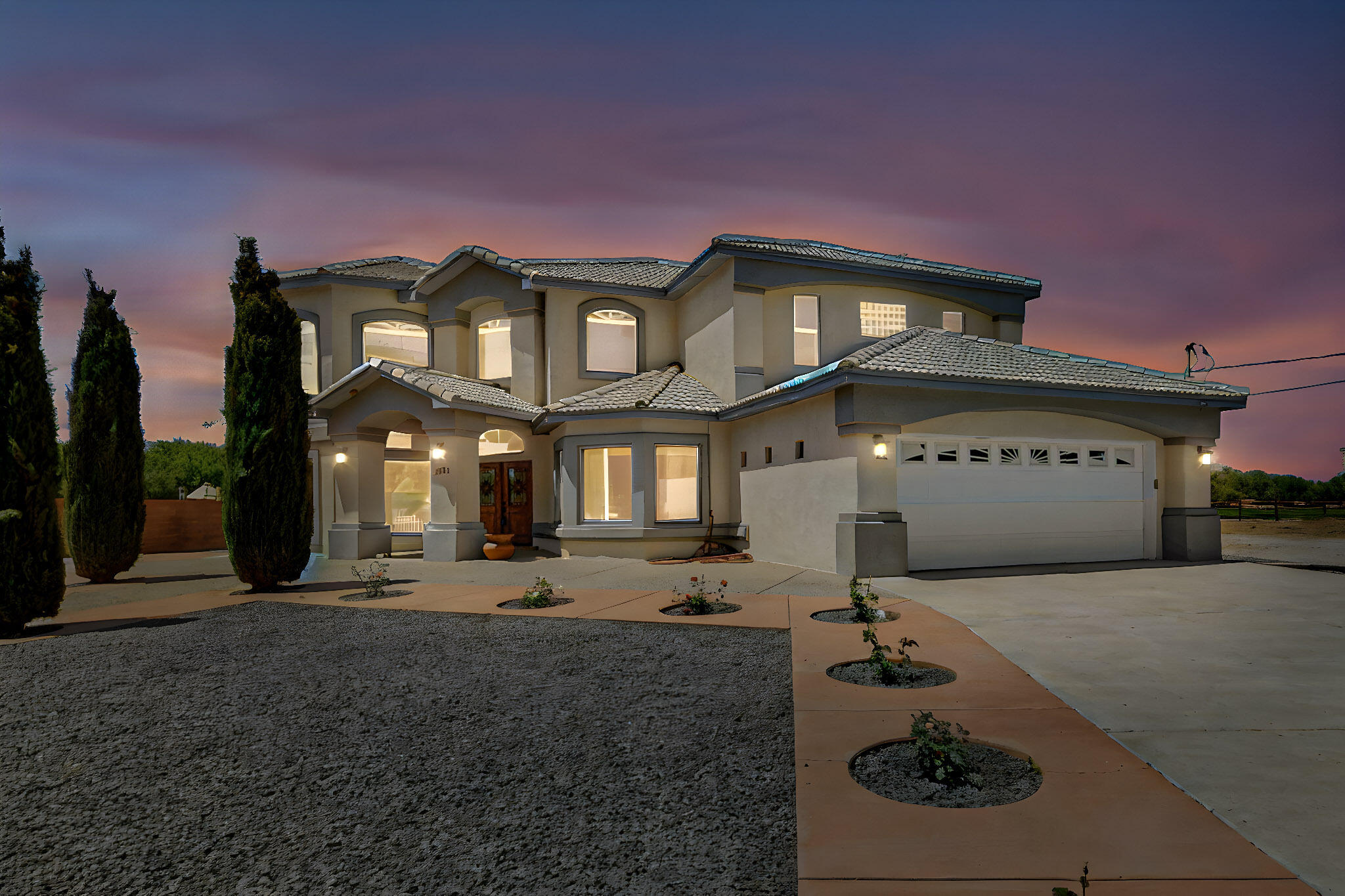 Owner to owner financing available! This one-of-a-kind luxury home is nestled in a highly sought-after, tucked-away neighborhood with million-dollar views of the Sandia Mountains. Set on nearly an acre with an agricultural feel and neighboring green pastures, it offers ultimate privacy and tranquility. The home features a newly stuccoed exterior, fresh paint, tile roofing, soaring ceilings, radiant heated floors, and two combo units with refrigerated air. The oversized kitchen island anchors a spacious, updated interior perfect for entertaining. Step onto the expansive balcony with custom decking to take in the stunning views. A fully finished 2-car garage, a detached 4 car garage/Workshop and updated workshop add incredible functionality. Multiple fruit trees.