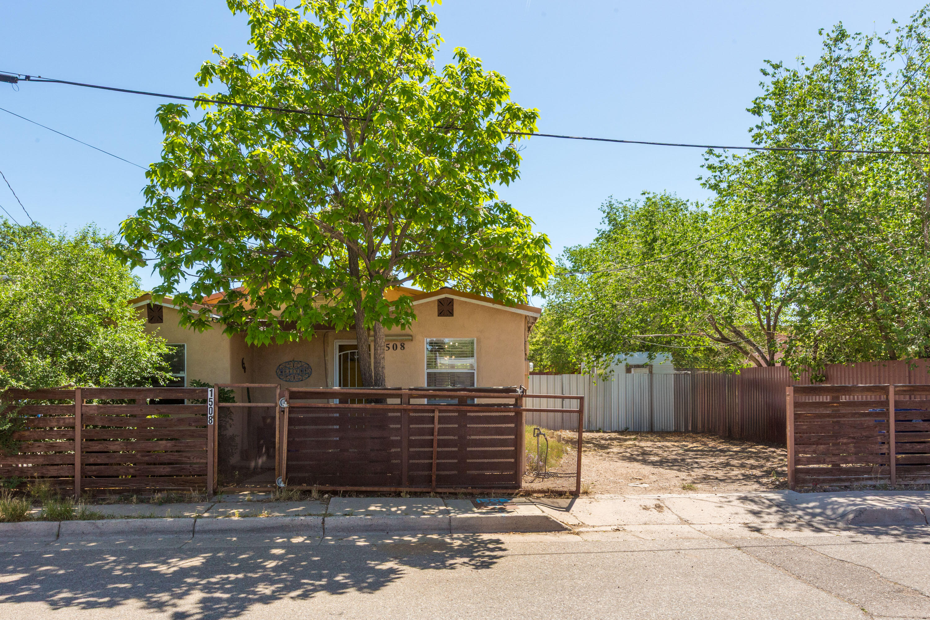 Welcome to this charming, original adobe home in the historic, vibrant Barelas neighborhood! Rare opportunity for mixed-use zoning with easy access to Downtown, ABQ BioPark Zoo, UNM, airport, freeway. Barelas Coffee House within walking distance. Gated and fenced home with an updated kitchen + bathroom. Open concept living, beautiful wood flooring throughout. Backyard oasis with fruit trees, patio, storage. Minutes to a multitude of shopping, dining, and entertainment destinations.