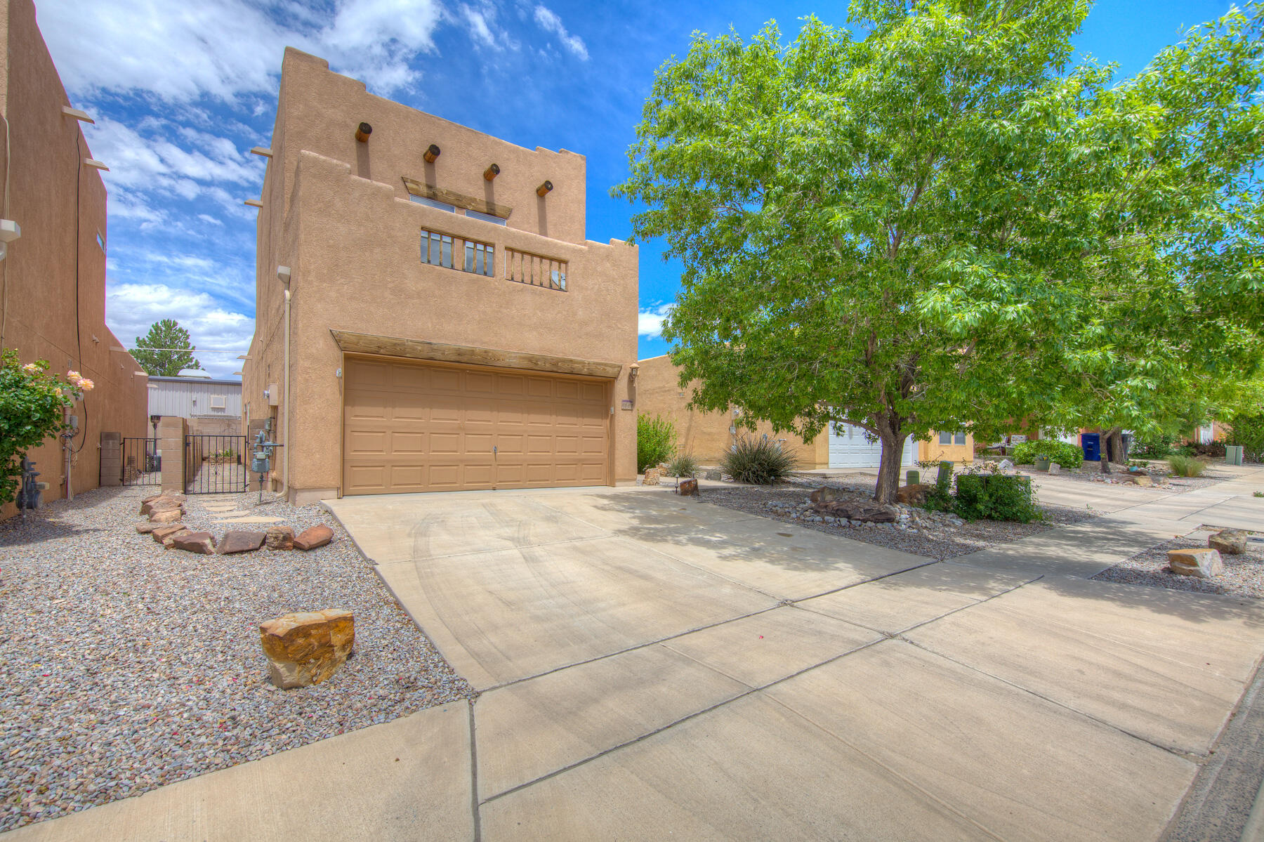 This lovely home is move-in ready! Freshly painted, new carpet, AC and digital thermostat replaced in 2022, and storage for days! Popular floor plan offers 3 bedrooms, 2 baths with cozy kiva gas fireplace in the living room. Enjoy a private master suite upstairs all by itself with a large walk-in closet and garden tub. Many upgrades include tiled kitchen, upgraded fixtures, Whirlpool Gold appliances, beautiful water feature, and much much more. Backyard has delicious blackberries and is ready to make the garden your own. Gated community is family-friendly, has kind neighbors, and away from noise and traffic. Close to KAFB and Sandia Nat'l Labs, Costco, Home Depot, and freeway. Schedule your appointment today!
