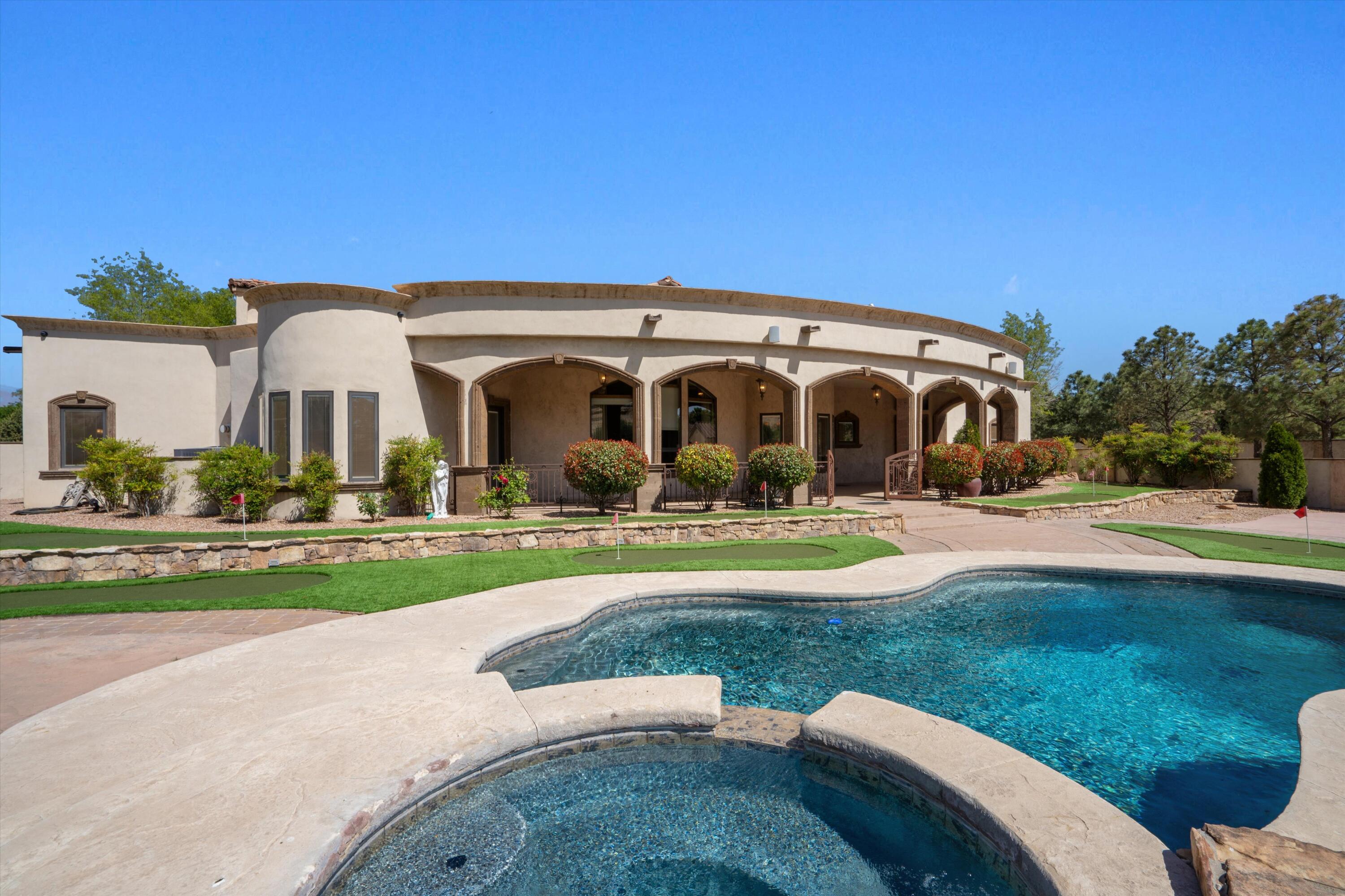 Experience resort-style living in this exquisite custom Earthstone home, set on a .75-acre lot in the prestigious Black Farm Estates. Rich designer finishes fill every space--Alder cabinetry, granite counters, Sub-Zero fridge, and a commercial-grade range highlight the gourmet kitchen. Roman columns lead to a stunning living area with soaring beamed ceilings and a grand fireplace. The luxurious primary suite offers its own fireplace, sitting area, and spa-like bath. Step outside to your private oasis featuring a sparkling pool, hot tub, cascading waterfall, full outdoor kitchen, custom fireplace, and mini golf course. 42 owned solar panels offer both efficiency and savings. Truly a one-of-a-kind retreat blending elegance, comfort, and unforgettable outdoor living.