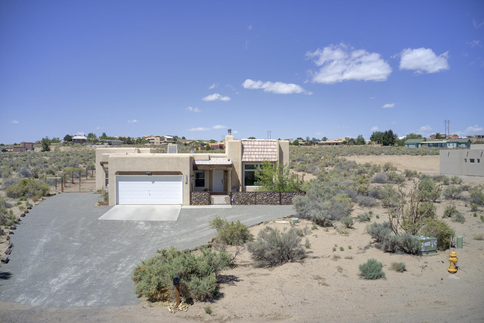 Welcome home to 1255 15th street in Rio Rancho. Situated on a generous half acre lot. This home features three bedrooms and two full bathrooms. Enter into the large southwest living room with tall ceilings, beautiful vigas, wood burning fire place, lots of windows exhibiting natural light and real adobe brick accents. Other features include a new TPO roof, new swamp cooler and water heater, fully tiled floors through out the home, a large sunroom, kitchen bar and oversized 2 car garage. You will not be disappointed with the gem.