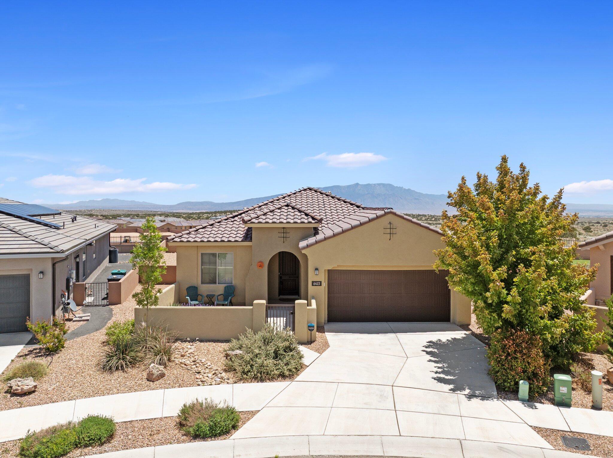 Stunning single story home perched on a rare, elevated lot in the gated section of Mariposa with breathtaking views of the Sandias and city lights.  3 bedroom plus an office & flex space + an extra large garage. Great curb appeal and welcoming courtyard sets the tone.  Inside you're greeted with beautiful ceramic tile & engineered hardwood adding warmth and style. The gourmet kitchen features granite countertops, built in appliances, custom backsplash and lighting.  Open concept layout with massive backdoor sliders that highlight the views from the large backyard patio! Primary suite is extra large with ensuite bathroom including a tiled walk in shower and generous closet. Tile roof, cul de sac, 8' doors, 1/4 acre lot + more!  Access to clubhouse, pools and trails!