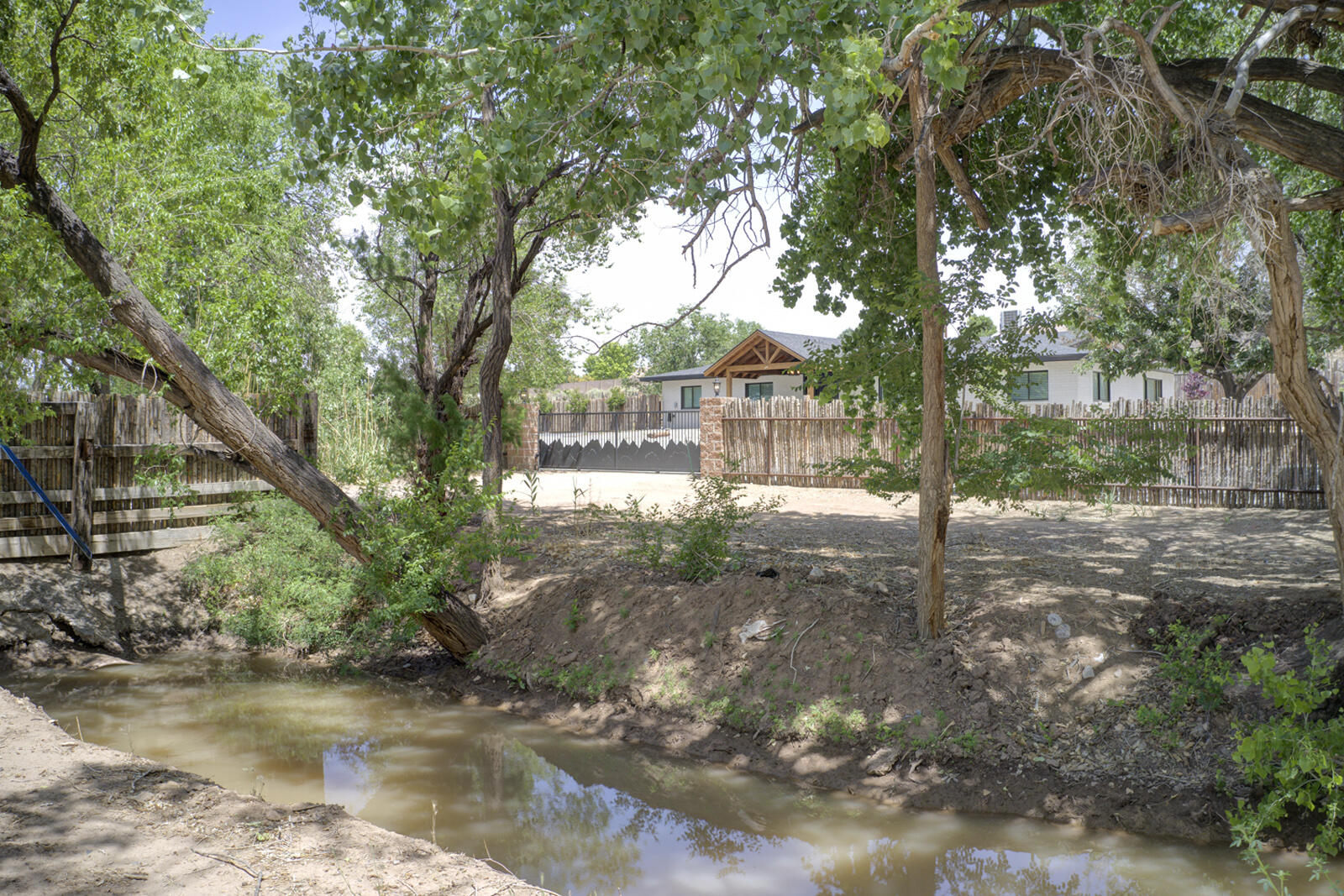Experience the perfect blend of privacy, luxury, and equestrian excellence with this stunning North Valley horse property formerly owned by Bobby Unser. This 2.5-acre estate offers breathtaking mountain views, creating a peaceful retreat. At the heart of this gated property is a beautifully remodeled 3,100+ sq. ft. home, featuring 4 bedrooms, 3 full baths, and an oversized 2-car garage. Modern living, with a cozy fireplace in the living area, extensive storage and high-end finishes that elevate every space. One bedroom boasts its own private entrance and full bath, perfect for a guest suite or home office.Equestrian enthusiasts will enjoy a 5,000 sf, 8-horse stall barn, tack room, and ample space OR convert barn to a garage to house a fine car collection. The possibilities are endless!