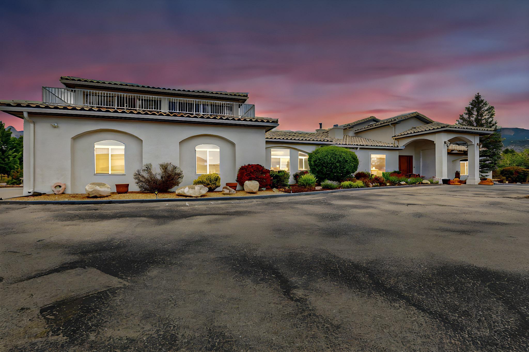 Behind a private gate on a landscaped 1-acre lot, this luxury estate offers true resort-style living. Features include a 20x40 pool with hot tub, UV filtration, waterfall, gazebo, gas fire pit, outdoor kitchen, full pool bath, tiled patio, and fruit trees. Inside: 4 en-suite bedrooms (2 masters), including a primary suite with dual closets, jacuzzi tub, and mountain views. Enjoy a grand entry, skylights, heated tile floors, office, modern kitchen with island, butler's pantry, and wet bar with mountain and fireplace views. Open layout with 2-way fireplace, large family room, and oversized utility room. Upstairs game room (25x25) has 360 views and a deck with gas hookup. Oversized 3-car garage with workshop.