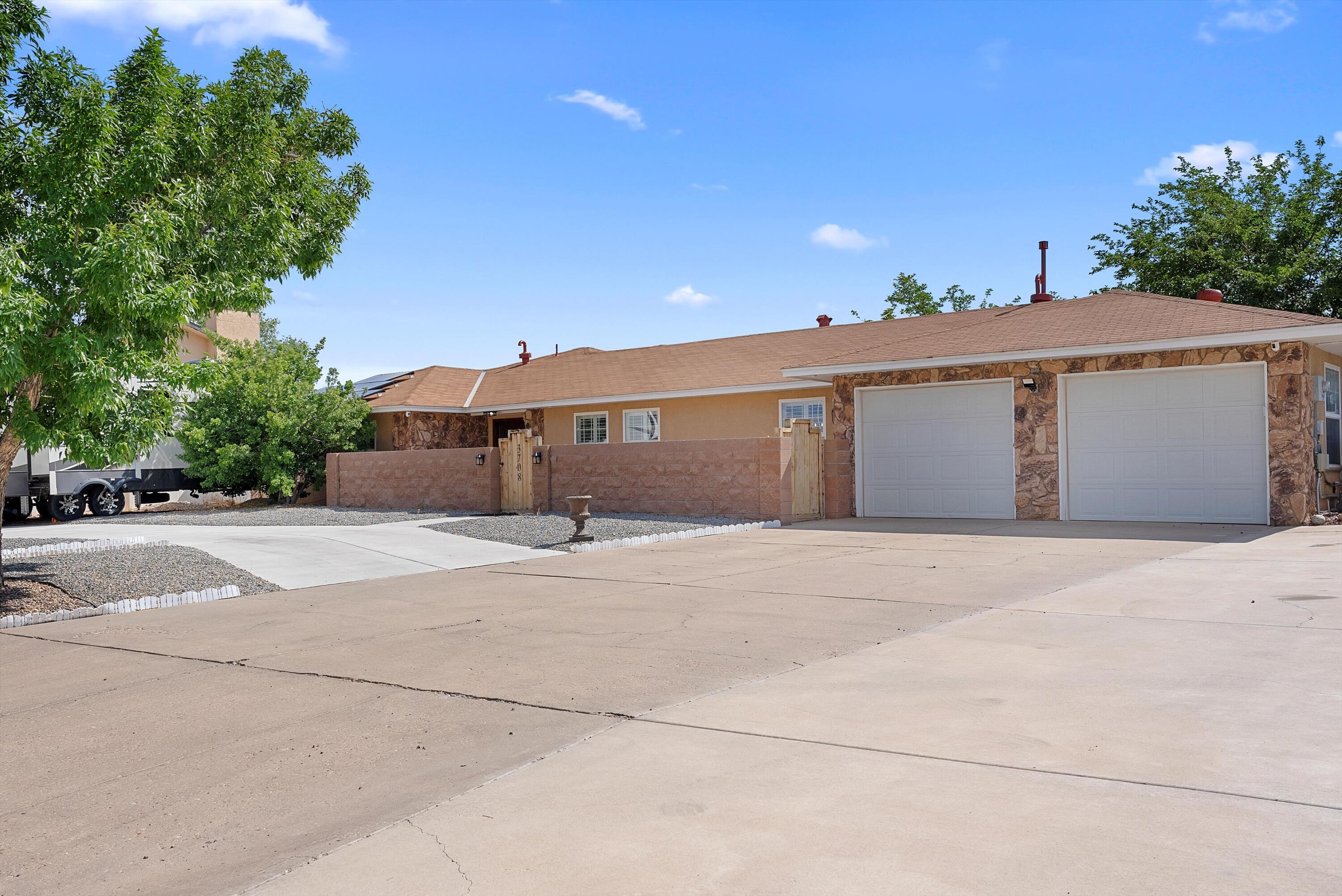 Elegant single-level 5-bedroom retreat on the historic Saint Andrews Drive in Rio Rancho! This sprawling home boasts tile floors, sleek granite countertops, and custom cabinetry, blending style with functionality. Nestled on a generous low-maintenance lot, it features a charming custom gazebo, ample parking for RVs or toys, and a convenient storage shed for all your needs. Perfect for relaxed luxury living  --don't miss this Rio Rancho gem!