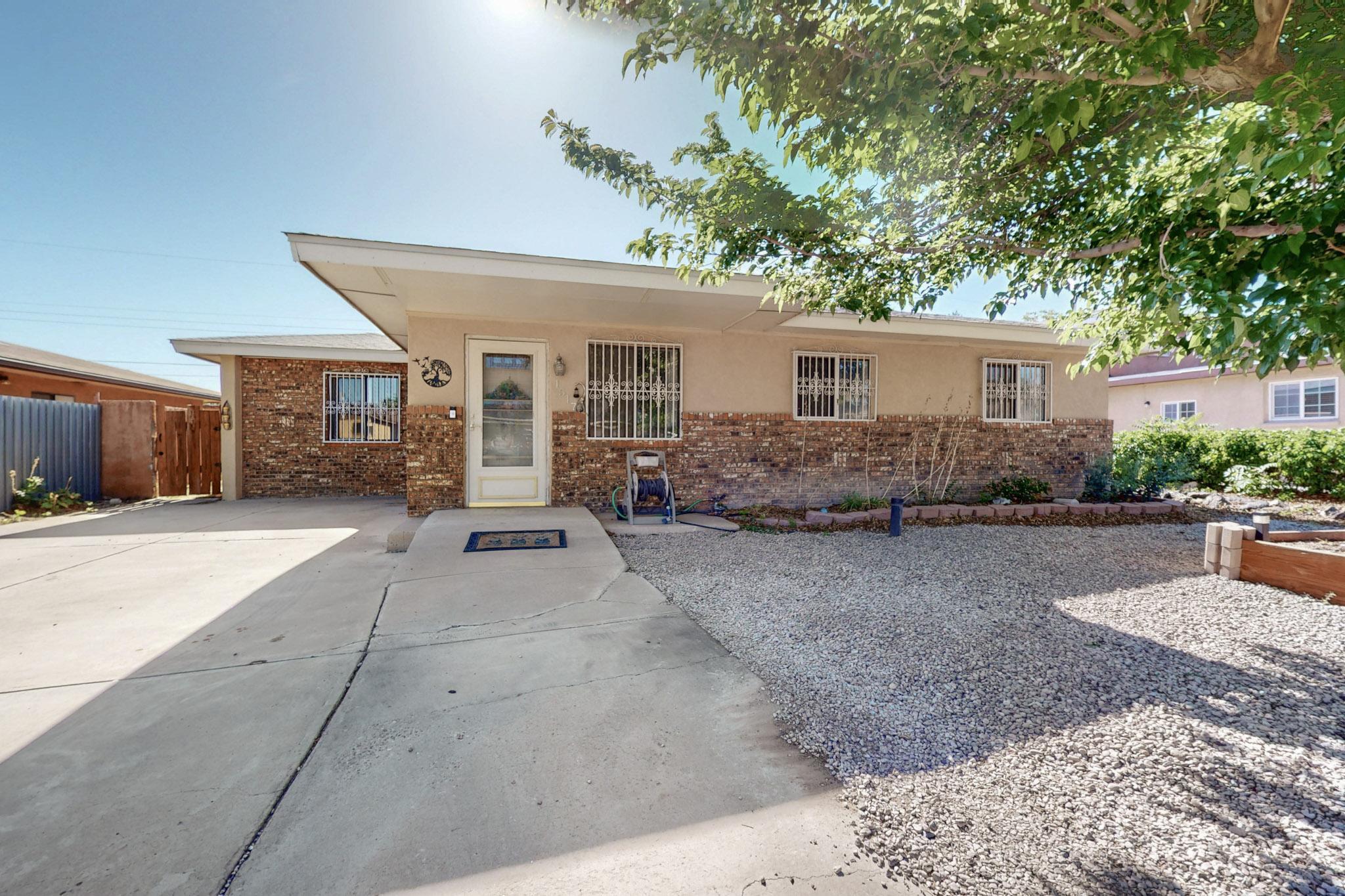 Conveniently located near I-40/Coors.  Recent updates include: Newer stylish laminate flooring (no carpet!) Stucco 2021, Roof 2016 by Otero Roofing, Furnace 2013.  Some of the great perks of this home: Tankless water heater, Spacious spare bedroom, Massive covered patio featuring a finished roomy shed with electric outlets and fan for your home hobbies.  Kitchen has an open floor plan with stainless fridge, & glass tile backsplash.  Bright sitting room in entry of home plus and great  sized living room with beautifully adorned rock wall &  wood burning stove to keep you toasty during those winter months. Iron-rod security throughout for your added assurance.  And best of all...two doggie doors so your fur babies can have rein of the roost!