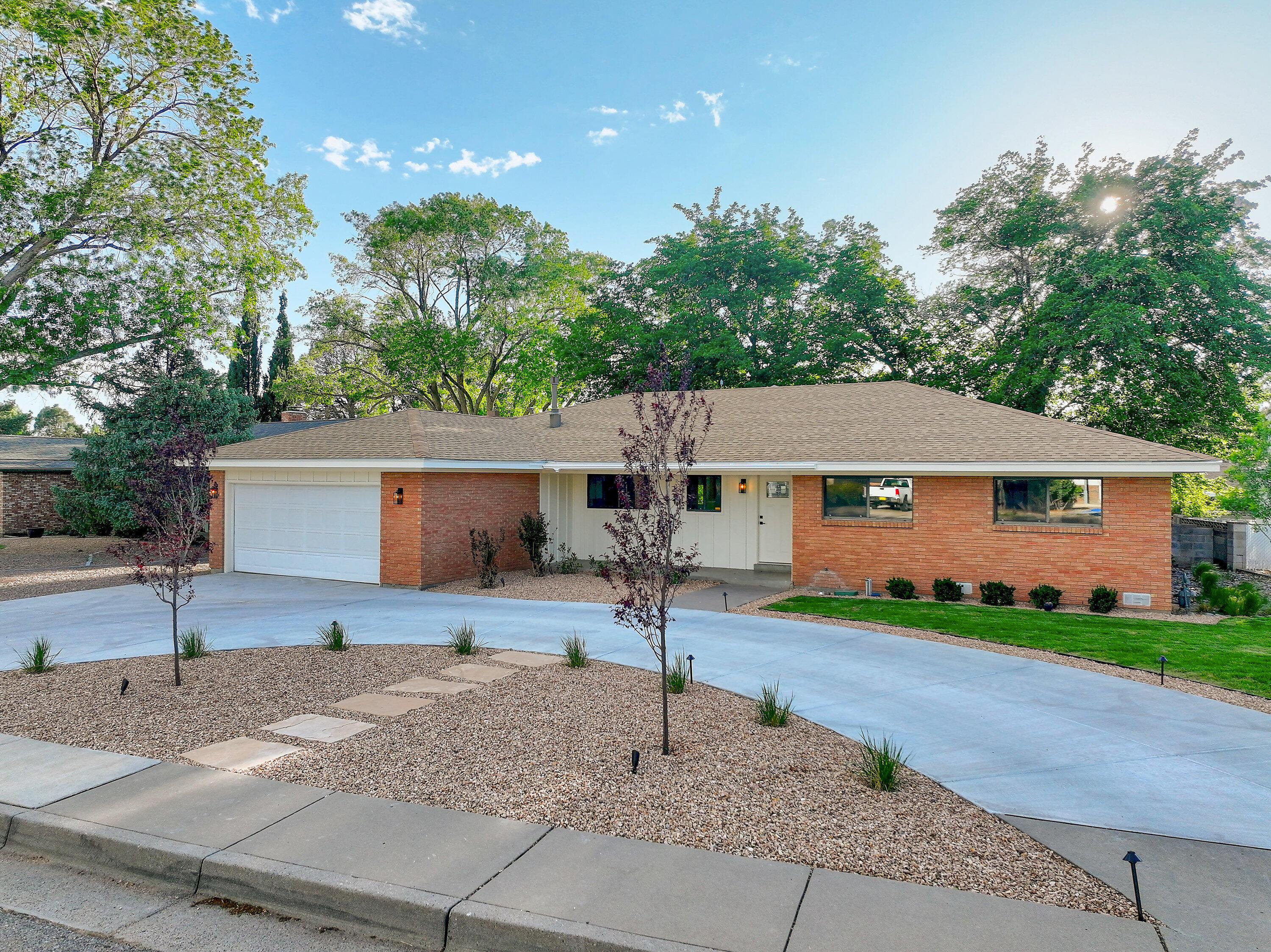 Experience Comfort and Style in This Fully Renovated Three-bedroom, two bath home situated on an expansive oversized lot. This stunning residence features a brand-new refrigerated air system and furnace, ensuring year-round comfort.The comprehensive renovation includes elegant hardwood flooring, modern bathroom vanities, stylish faucets, and updated recessed lighting throughout. The kitchen is equipped with sleek stainless-steel appliances, including a refrigerator, and enhanced with contemporary tile and backsplash finishes.Step outside to enjoy meticulously designed landscaping complemented by exterior lighting--perfect for relaxing evenings or entertaining guests. The open-concept floor plan offers spacious living areas and spectacular views of the Sandia Mountains.