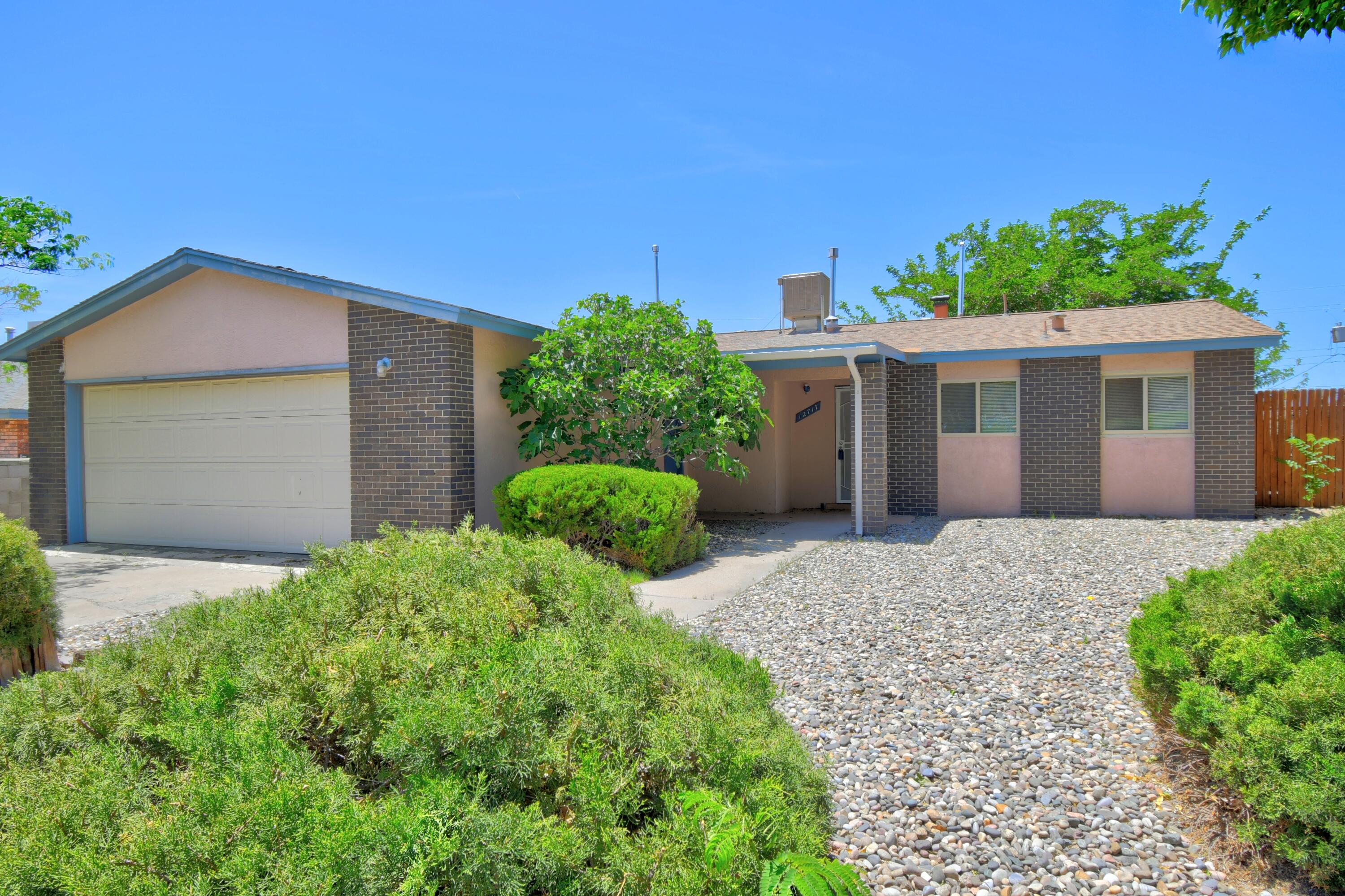 Welcome to this charming 3-bedroom, 2-bathroom home in the heart of the NE Heights! Situated right across from a delightful park and playground, this home offers a wonderful setting for anyone who enjoys green space just outside their door. Inside, you'll find a cozy living area with a fireplace, ideal for those crisp Albuquerque evenings. The home features a spacious backyard with covered patio, perfect for relaxing, entertaining, or playtime. With a 2-car garage and easy access to the freeway, Sandia Labs, shopping, and restaurants, this location can't be beat. Don't miss your chance to make this well-loved gem your own!
