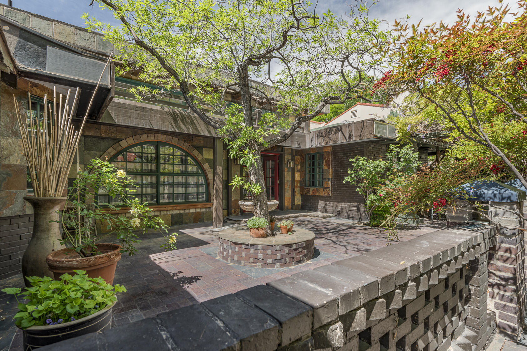 Experience the timeless elegance of this charming single-level home nestled in the desirable Albuquerque County Club neighborhood. Surrounded by mature landscaping, the residence boasts a welcoming courtyard entry that sets the tone for warmth and sophistication. Inside, you will find vintage details throughout that add character and charm, complemented by a thoughtfully designed kitchen featuring commercial-grade appliances. In addition to the two bedrooms, there are multiple living areas plus a spacious enclosed patio. This unique home offers style and many outdoor living spaces in a sought-after location, making it a special place to call home.