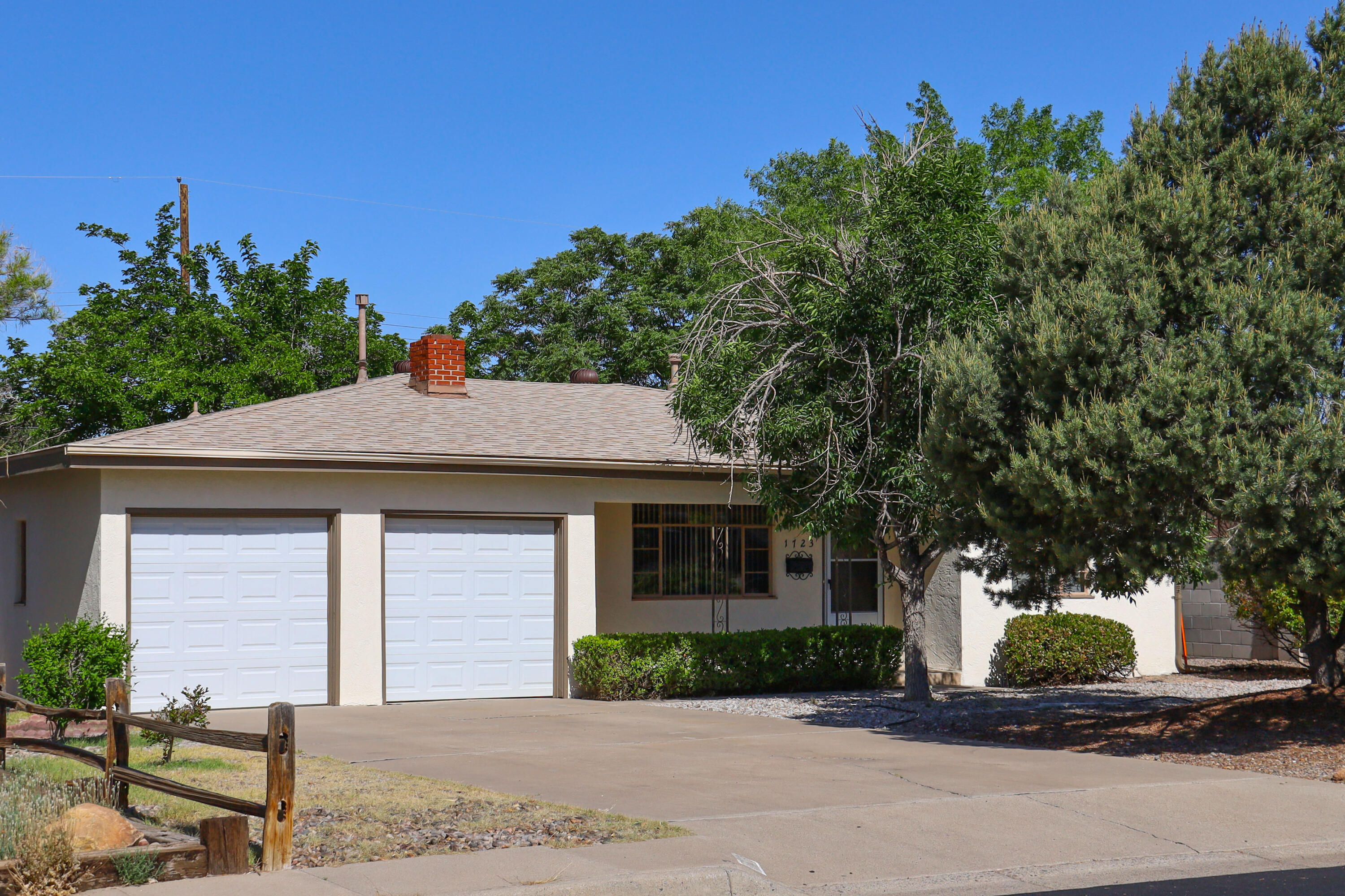 Mature neighborhood.  Well cared for 3BR, 1+3/4 Bath with 2 Car Garage.  Open floor plan with formal dining and huge great room with a cozy, wood burning fireplace. Hardwood floors.  Enjoy your spacious patio and wonderfully shaded backyard.  Good freeway access and UNM area.