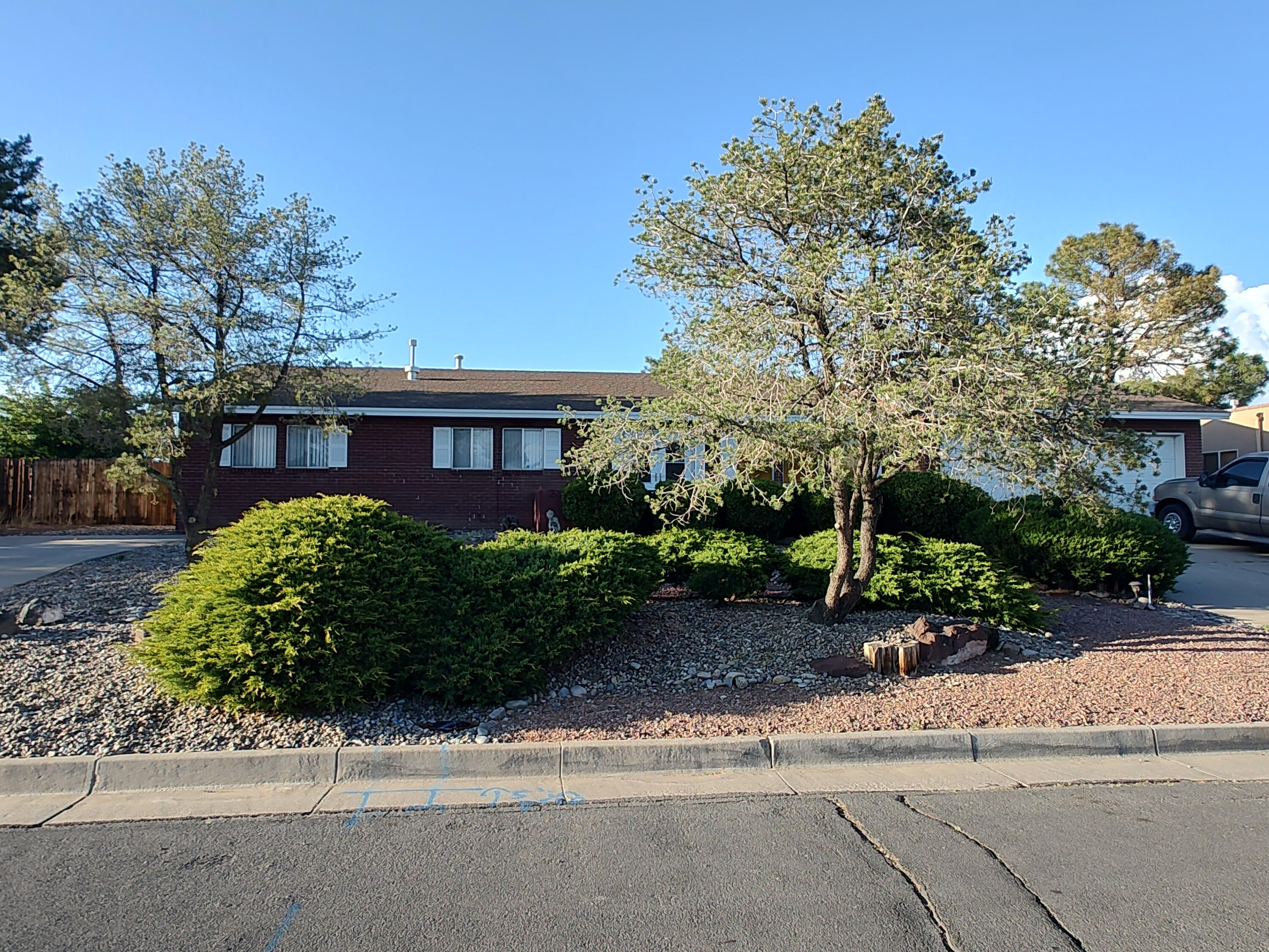 Single story 2000+sf home on a large 1/3-acre cul-de-sac lot in good condition.  Upgrades include refrigerated air, fresh paint, newer carpet in family room and a brick wood-burning fireplace.  There are 2+ living areas, with a big formal dining/office area next to the large, open kitchen loaded w/tons of counter space and cabinets.  Lots of parking including a 2-car garage and RV parking area with back yard access possible.  There is a covered patio overlooking the fully landscaped yard with mature trees, natural gas grill and even a view of the Sandia Mountains. The property is situated in a quiet area of the centrally located neighborhood of Corrales Heights.  This one is well maintained and ready for a new owner.