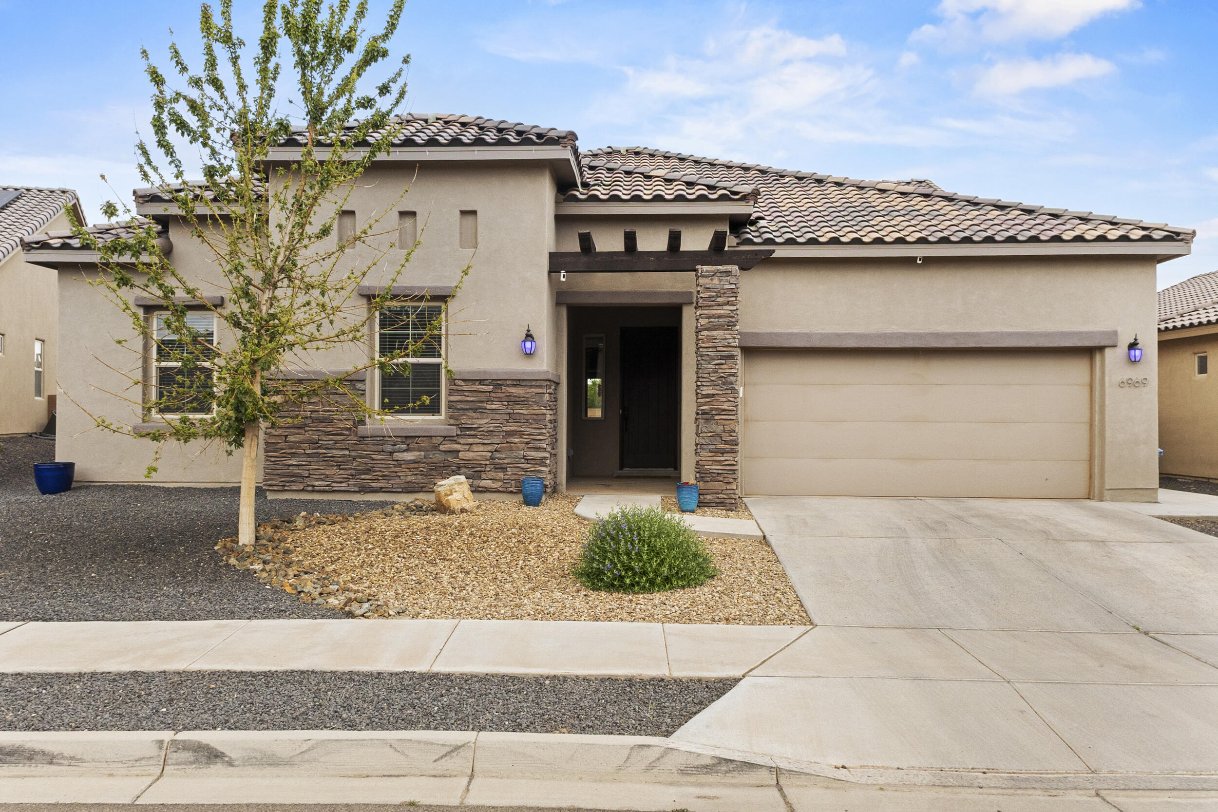 Check out this Luxurious single story home in Lomas Encantadas! You are immediately greeted with a beautiful stacked stone exterior as you pull up to the home. This 2,752 sq ft beauty features 5 beds, 2.5 baths, and a 3-car tandem garage. Enjoy custom wood plank tile and upgraded LVP flooring--NO carpet! The open concept living area includes a gas fireplace and wood-beamed recessed ceilings. This true Chef's kitchen offers espresso cabinets, high end granite counter tops, gas cooktop, built-ins, and a large island. Spacious owner's suite has a spa-like bath with dual sinks, oversized vanity, dual shower heads, and a luxurious walk-in closet. Enjoy a fully walled backyard with covered patio and stunning mountain views. Close to 528, I-25, shopping, dining, and breweries! Don't miss out!