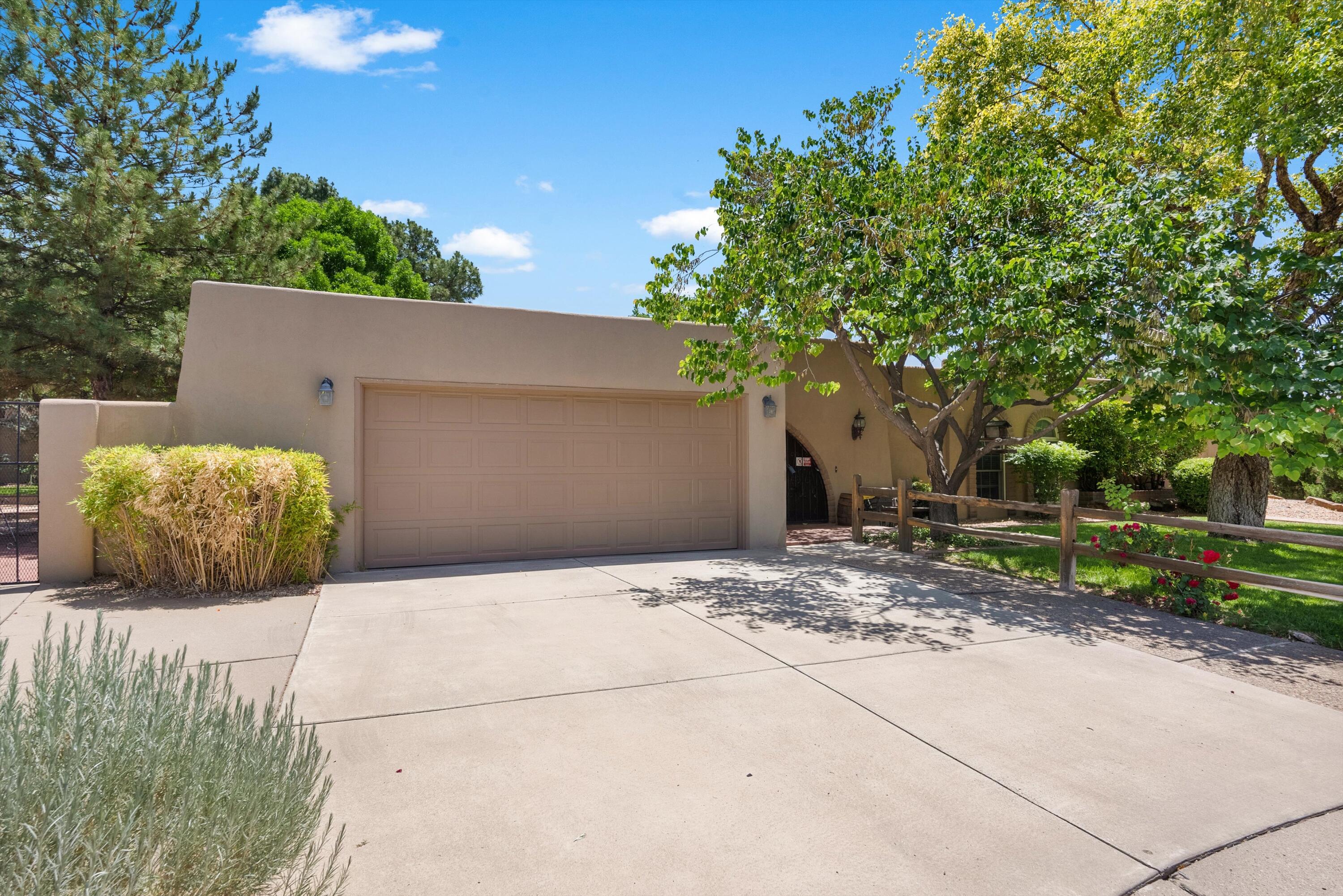 Exceptional Opportunity in a Prime Location. Tucked away in a quiet cul-de-sac near Albuquerque Academy, this single-story home sits on an oversized, lushly landscaped lot-- one of the best settings we've seen. The backyard is a true retreat, featuring a sparkling inground POOL ,generous covered brick portals, expansive grassy areas, and mature trees--perfect for outdoor living. The home offers nearly 3,000 square feet of space with 4 bedrooms, a 2-car garage, and a private entry courtyard with charming brick patios. Inside, the layout is spacious, though dated--which presents a great opportunity to update in an unbeatable location. This property combines convenience, privacy, and potential. Homes in this kind of setting are rare! It's one of our all time favorites!