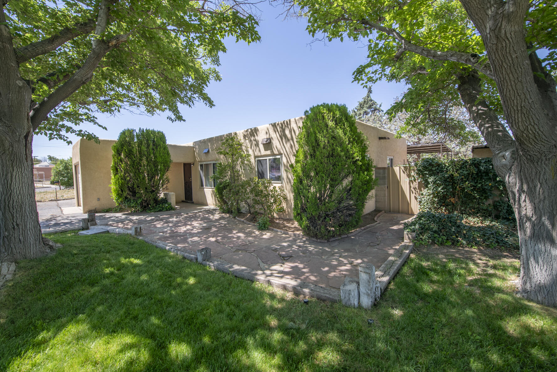 Welcome to this beautifully updated 3-bed, 2-bath home in Albuquerque's sought-after NE Heights. The fully remodeled kitchen boasts granite countertops, newer cabinetry. Enjoy two spacious living areas, one featuring a cozy wood-burning fireplace. Modern comforts include refrigerated air, newer tile flooring, and new carpet in two bedrooms. The lush grass front yard and walled backyard with a storage shed offer ample outdoor space. Parking is convenient with a garage and covered 2 car carport, and extended driveway. Located near Sombra Del Monte Elementary, Madison Middle, and Sandia High School, and just minutes from Coronado Center and ABQ Uptown shopping. Nearby parks include El Oso Grande Park, Academy Hills Park, and Arroyo del Oso Park, perfect for outdoor activities. Come get it!