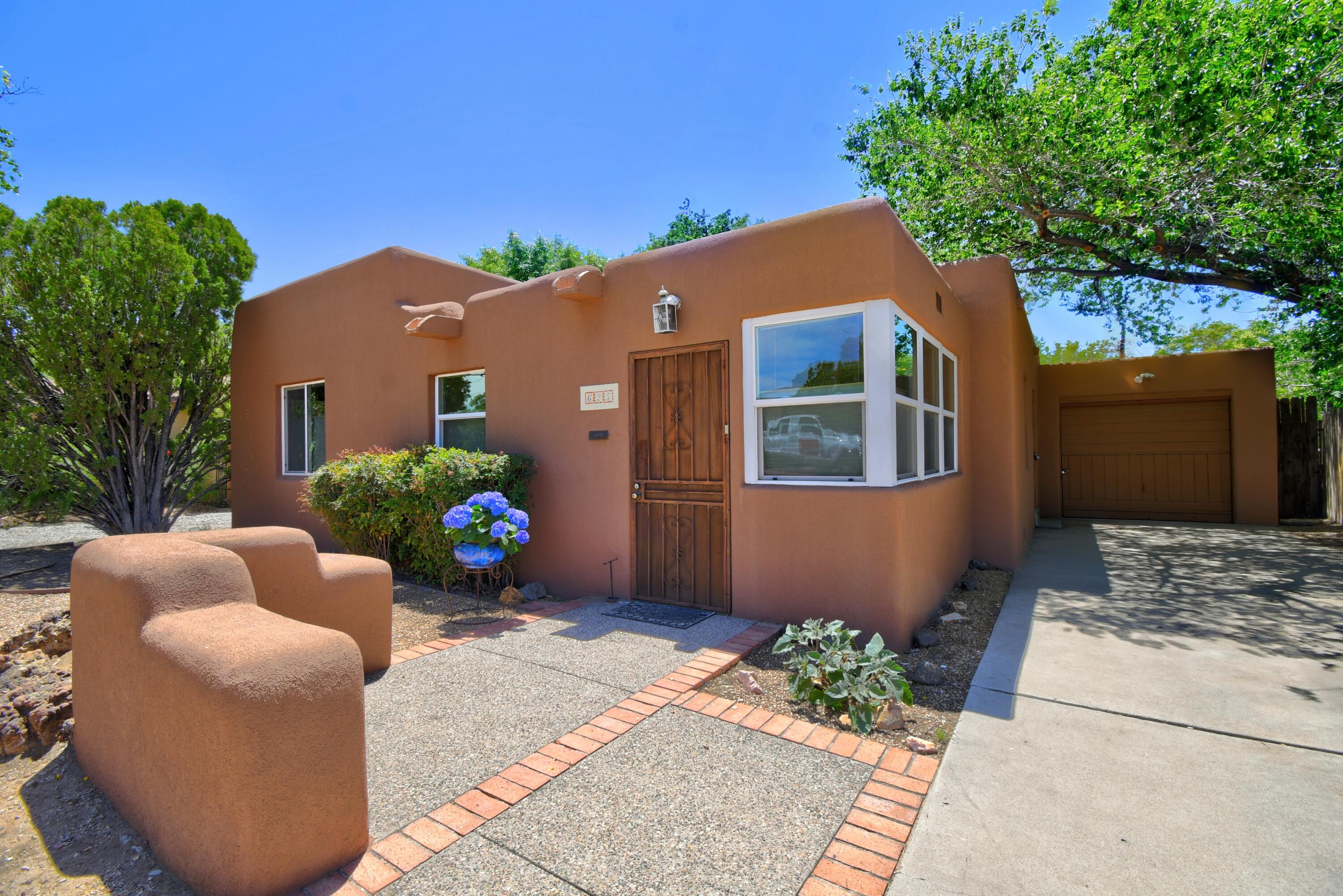 Welcome to this charming Pueblo-style home situated in the vibrant, desirable area near Nob Hill & a sought-after school district. You'll be greeted in the foyer with an all-brick nook perfect for a cozy sitting area, office or green room. Enjoy a nice bright living area showcasing a lovely wood fireplace open to the dining area & real hardwood floors. The kitchen overlooks the foyer and all the natural light it offers. Adjacent is a mudroom, a pantry, and a separate laundry room. You'll appreciate the nicely sized bedrooms and one that offers a serene backdrop with French doors opening to the large, private backyard, with the possibility of full backyard access if needed. This property is a beauty as is, and offers an abundance of possibilities. Many updates have been completed,