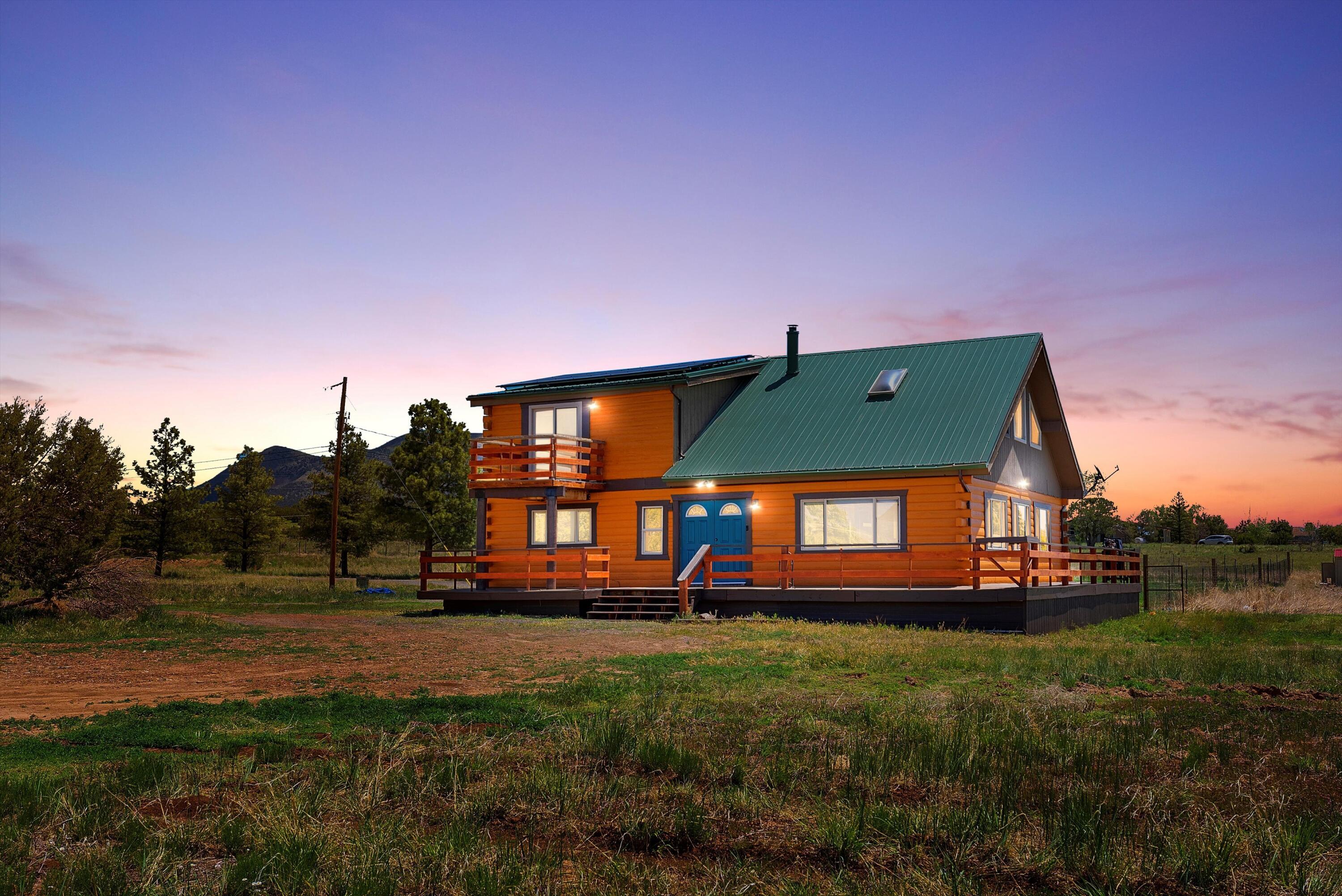 Experience high mountain living in this beautifully renovated cabin-style home in Sandia Park! Set on over 5 acres with stunning Sandia Mountain views, this 3-bed, 2-bath retreat features cozy rustic charm with wood-burning stove. Brand new 5.16 kW PV Solar electric system owned and paid off! Enjoy open skies, peaceful surroundings, horse stables, and a detached garage--perfect for outdoor lovers. A rare mix of privacy, character, and functionality just a short drive from Albuquerque.