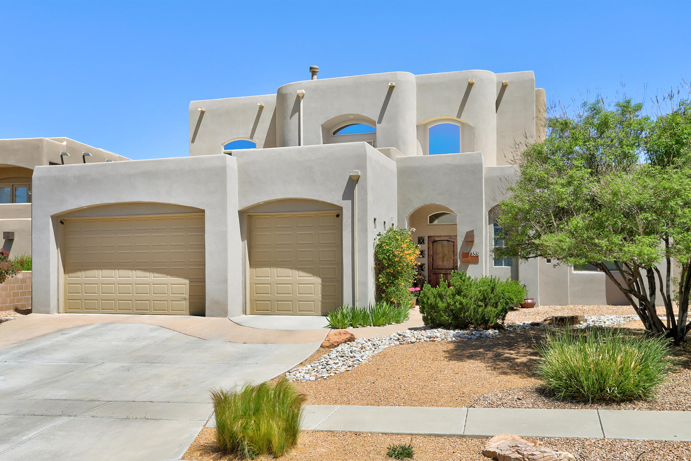 This gorgeous custom 5 bedroom home has it all including a new roof, new stucco, EV charger and spectacular city and mountains views. Dramatic 12 ft - 24 ft high ceilings. Gourmet kitchen with large island, maple cabinets, granite countertops, double convection ovens, 6 burner gas cooktop, built-in refrigerator, wine cooler and large pantry. Luxurious primary suite includes a gas fireplace, private deck, spacious bathroom with jacuzzi tub, walk-in dual head shower and huge walk-in closet with custom cabinets and shelving. Large secondary bedrooms - one could be a 2nd primary suite. Beautiful Tavertine flooring throughout. Carpeting in all bedrooms. Oversized garage. Fabulous backyard is perfect for entertaining with custom built kiva fireplace, built-in grill, and newer pool and hot tub.