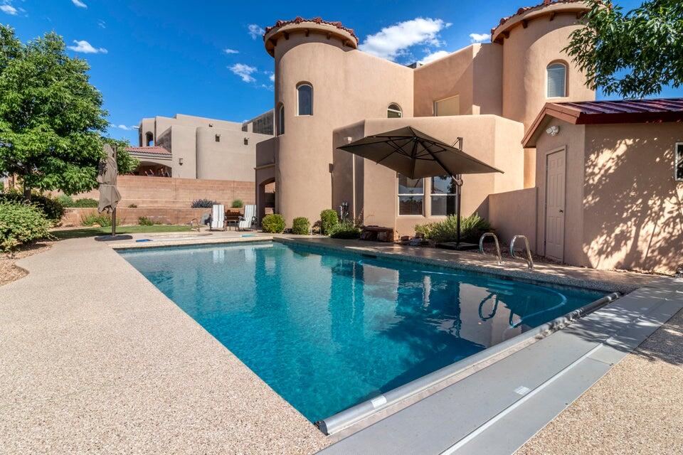 Owner finance available  pool Property with Hot tub cared for and views of the Sandia mountains/ Breathtaking architecture & gorgeous landscaping Abound in this 3 plus bedroom, 2.5 bathroom in a cul-de-sac on a corner lot home. Be greeted by an Exquisite front walkway .door and foyer with, natural light streams in from the clerestory windows above, leading your great room with gas log fire place. Kitchen boasts newer Bosch appliances, island and spacious breakfast nook. Butler's entry to the Dining room. Newer roof, stucco, 2 AC units/furnace and water heater! Primary bedroom is on the first floor as well as an additional bedroom on this floor. Second floor, features loft , views covered in beautiful hard wood, two bedrooms and deck. North star , Dessert Ridge and La Cueva