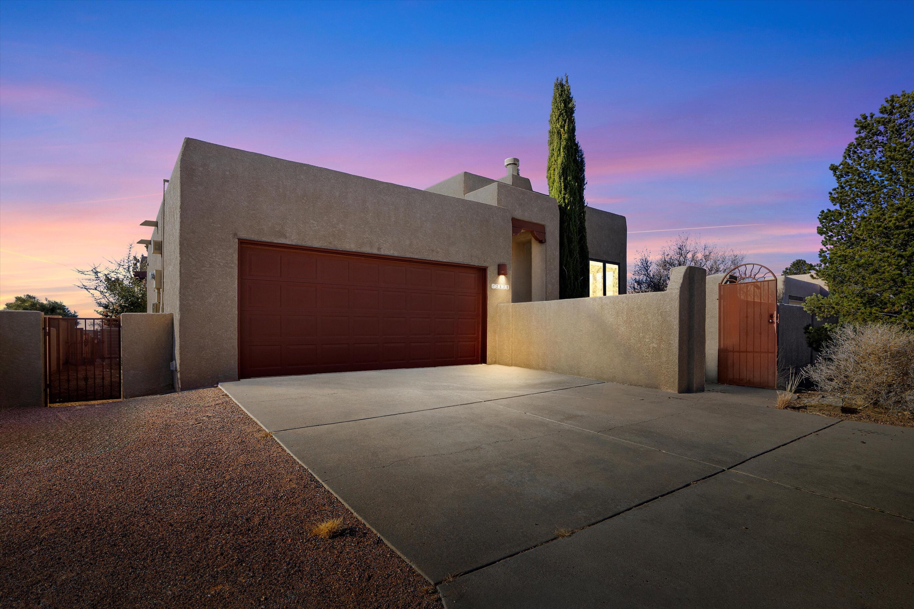 BREATHTAKING MOUNTAIN VIEWS AWAIT IN THIS SANDIA HEIGHTS RETREAT! Step through the charming courtyard entrance into a stunning one-story home where beam ceilings and premium tile flooring create an atmosphere of warmth and elegance. Cozy up by the kiva gas log fireplace in the open living area, with no carpet in sight. The galley kitchen boasts a built-in oven and cooktop. Upgraded Pella windows, two HVAC units, and two hot water heaters ensure comfort year-round. Relax on the covered porch, surrounded by mature landscaping and flowering trees. Just minutes from Elena Gallegos Open Space, this move-in-ready gem won't last. Schedule your showing today!