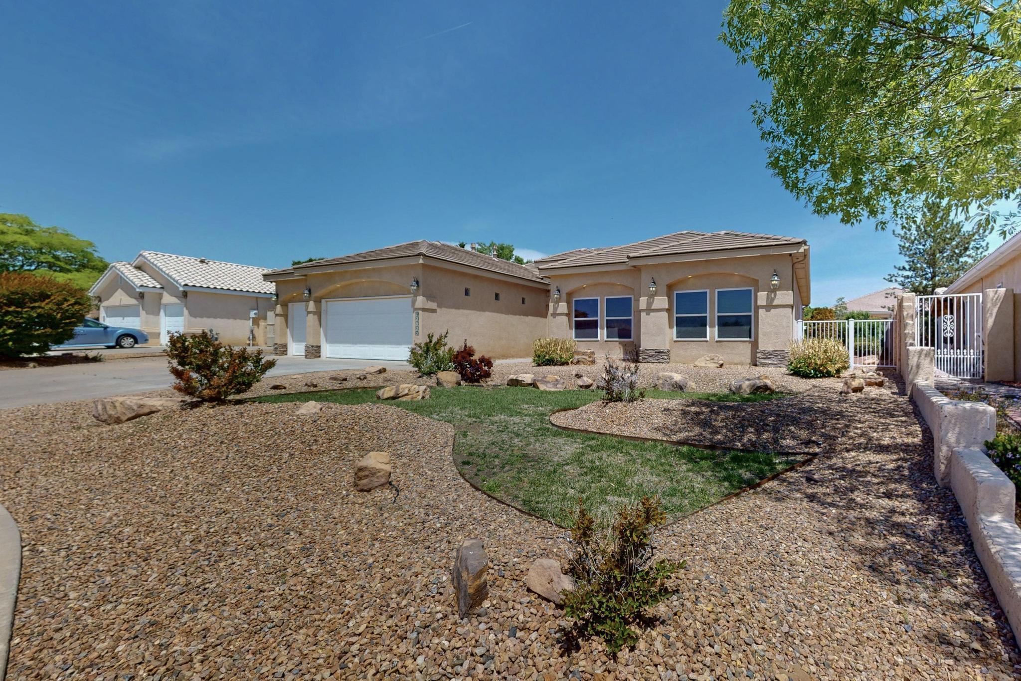 Exquisite custom built home centrally located in Rio Rancho. Wonderful layout with ample privacy between the primary bedroom and secondary bedrooms.  All bedrooms are spacious, and primary bedroom features access to back patio, bathroom with dual sinks, jetted tub, double-sided fireplace and a closet grand enough for any fashionista!  Beautiful granite counters in kitchen with semi-circular raised bar area for additional seating.  Also features lovely maple cabinets, gas cooktop, desk area, and abundant pantry space.  Thoughtful architectural touches highlight the home. Multitude of closets throughout, and a 3 car garage. Backyard provides a ton of shade with its large covered patio area and also sizeable permanent shed.  Space on the West side of the property to store your camper or boat