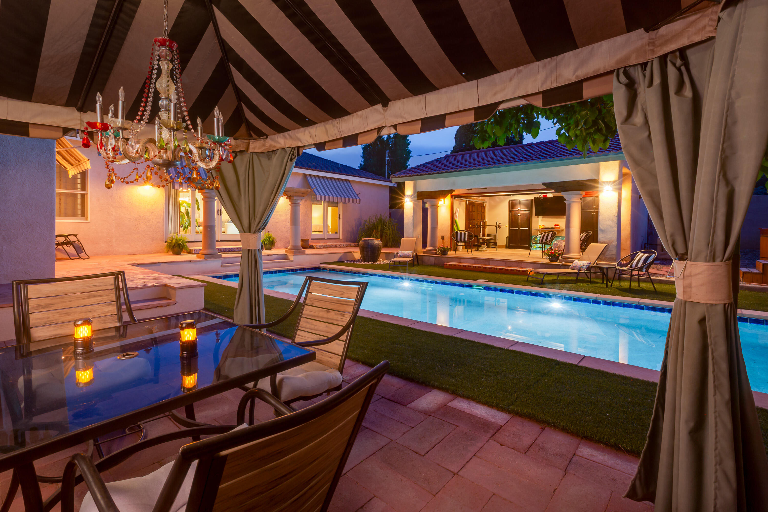 Timeless elegance in the heart of ABQ Country Club.Completely remodeled creating an open flowing floor plan between generous living, dining, den & kitchen spaces.Dramatic view to heated salt water pool from kitchen & den. Kitchen w/island, gas range, stainless appliances,& brkfst nook. Primary bdrm is split from other bdrms & is a true retreat! Dressing area w/custom storage, walk-in closet plus walk THROUGH closet for boots, shoes & purses! Access pool from this peaceful space. Each addtnl bdrm has access to bathrm. 1 bedrm also accesses pool. Fantastic cabana space offers additional outdoor living options plus Japanese hot tub, outdoor fireplace & cooking area.Short distance to Country Club and beautiful tree lined medians. Holidays will include luminarias & glowing hot air balloons.