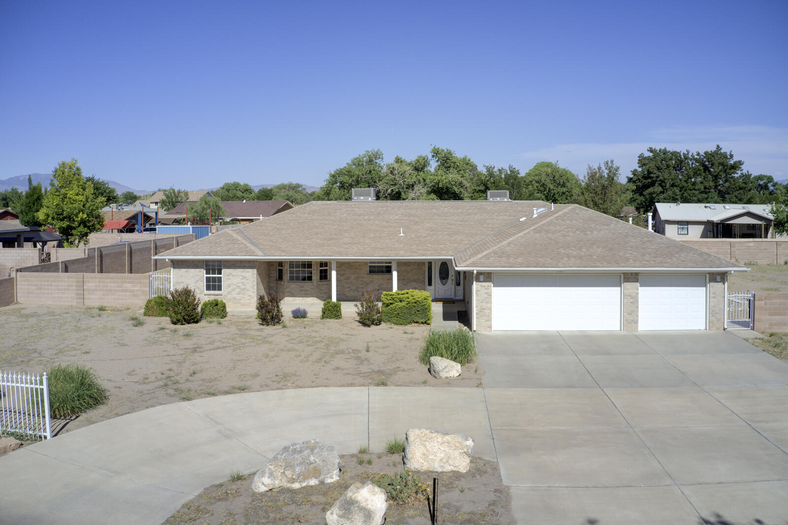Stunning South Valley Brick home offers thousands in Abundant Upgrades & Updates! Large Great Room is the Heart of the Home, featuring a Brick Fireplace & New Carpet! Access to the rear covered patio is ideal for entertaining/relaxing!  Dining room has a Shadow Box ceiling & New flooring! Updated Cabinets & Granite Counters in Kitchen! New Appliances, refrig/microwave/wall oven and dishwasher have been replaced! Spacious private primary suite beckons you to relax with a sitting area & spa bath! Jet tub/dual sinks, and accessible shower! Usable 1/2 acre lot with 434+/- Linear feet of block wall! Room to Build Shop/Barn! Sought-after Don Felipe Estates! Radiant Floor Heat/Refrig Air! Landscaped w/ rocks, boxwood/Trees! 828 SF 3 car garage w/storage! Private well/city water available!