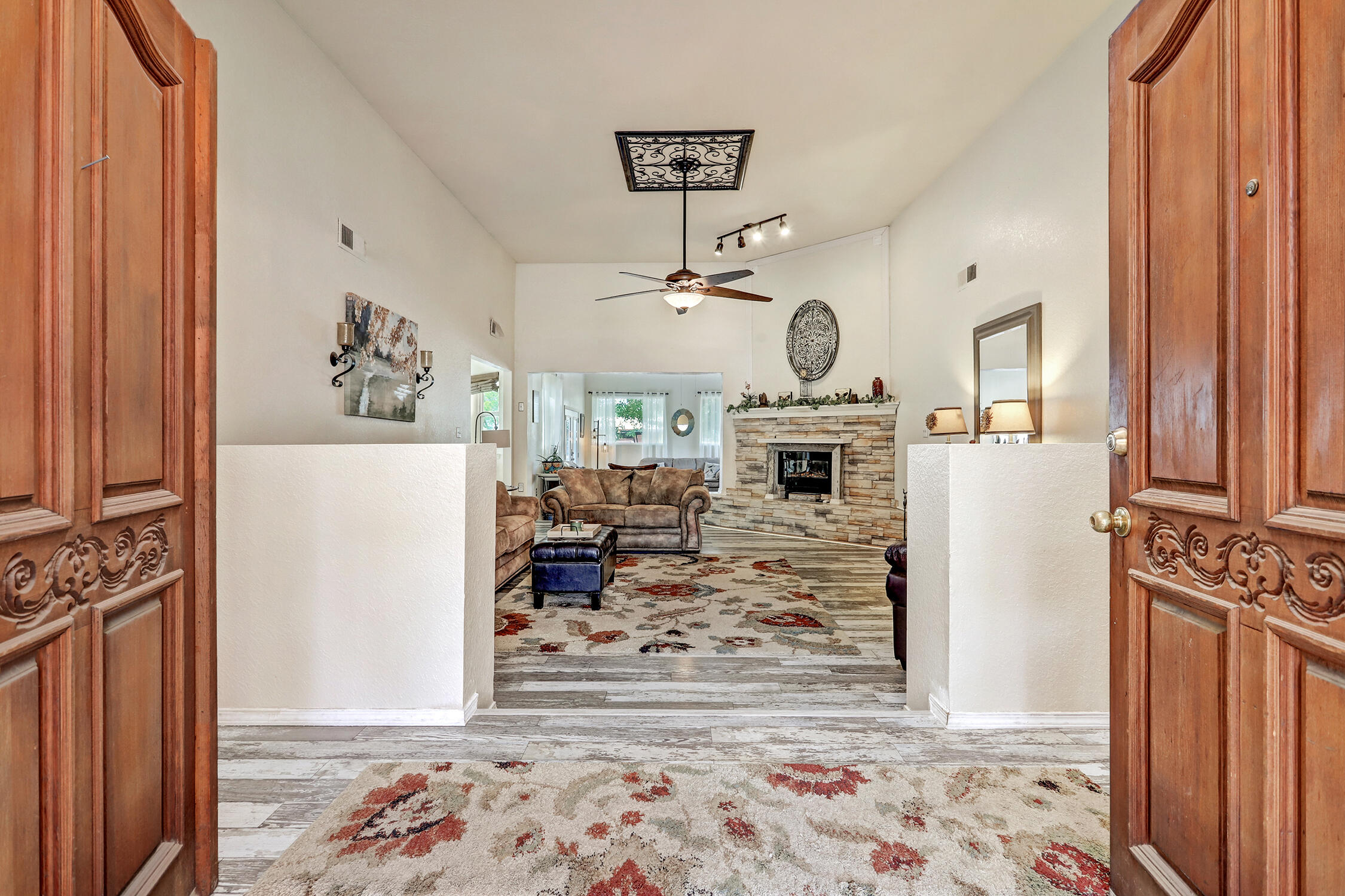 Take a look at this beautifully updated equestrian property on 2 acres in Bosque Farms! The home features 2+ living areas, formal dining, and a bright kitchen with island, breakfast nook, and abundant counter space. The primary suite offers a large bath, sunroom, and private patio. Recent upgrades include a 200-amp electric panel, new HVAC, hot water heater, windows, stamped concrete patio, and garage updates including insulation, tongue & groove walls, and a new door. The 8-stall barn features 14x14 stalls with 14x20 runs on 7 stalls, plus individual feed and tack rooms. Trail and ditch access makes this an ideal place for exploring. This home will make all of your country living dreams come true.