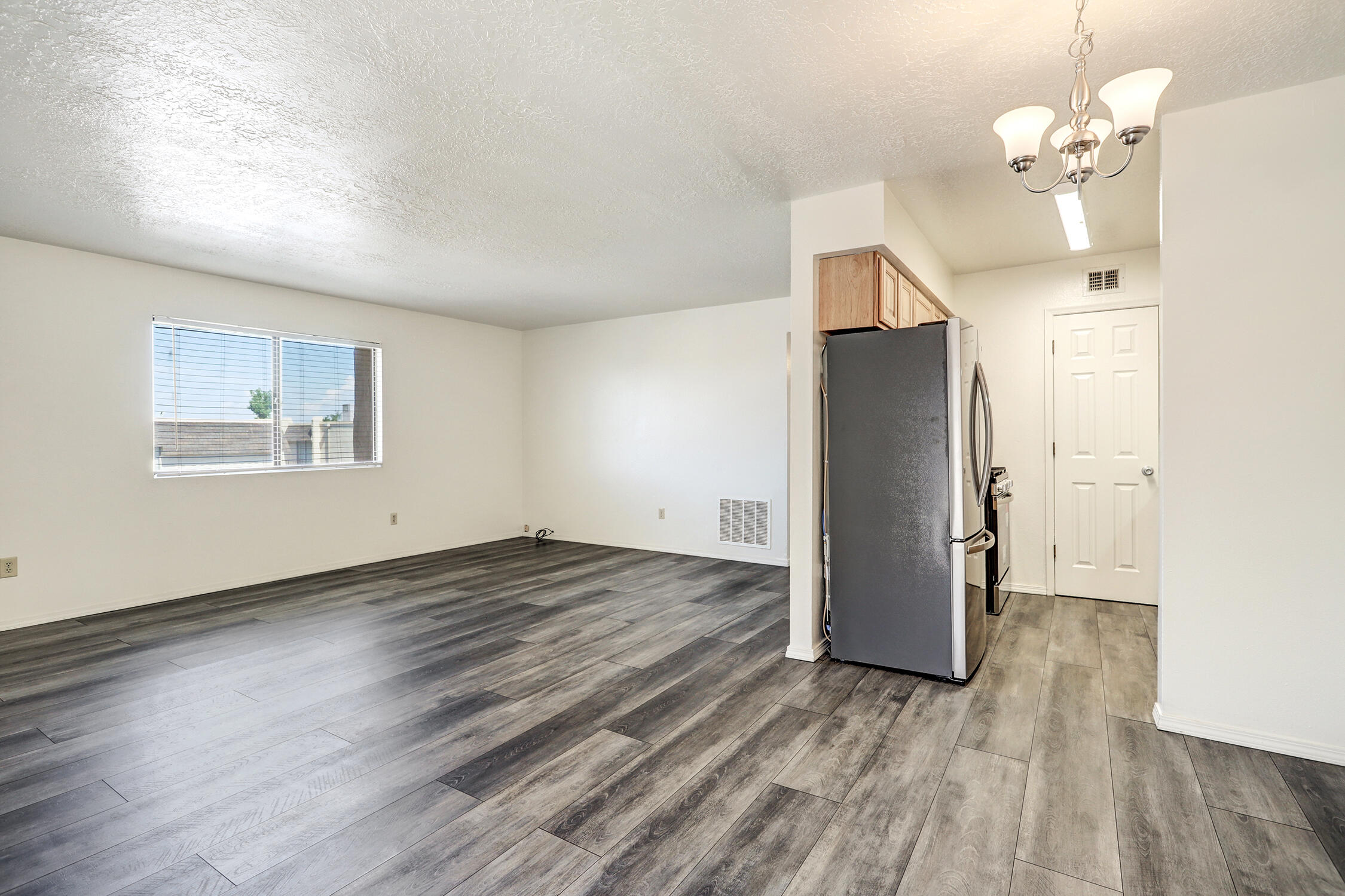 Tucked into the desirable NE Heights, this charming 2-bedroom, 1-bath condo is more than just a place to live--it's a lifestyle. Stylish & updated, you'll love the fresh feel of the modern kitchen, complete with new appliances & sleek finishes that make cooking feel like a treat, not a chore. The bathroom? Beautifully renovated with the kind of clean, contemporary vibe you crave.Say goodbye to carpet--this home features hard-surface flooring throughout for a streamlined look and easy maintenance. Enjoy the perk of a 1-car garage (because yes, covered parking is a big deal), and the unbeatable convenience of being directly across the street from restaurants, shops, & local favorites--all walkable, all within reach.