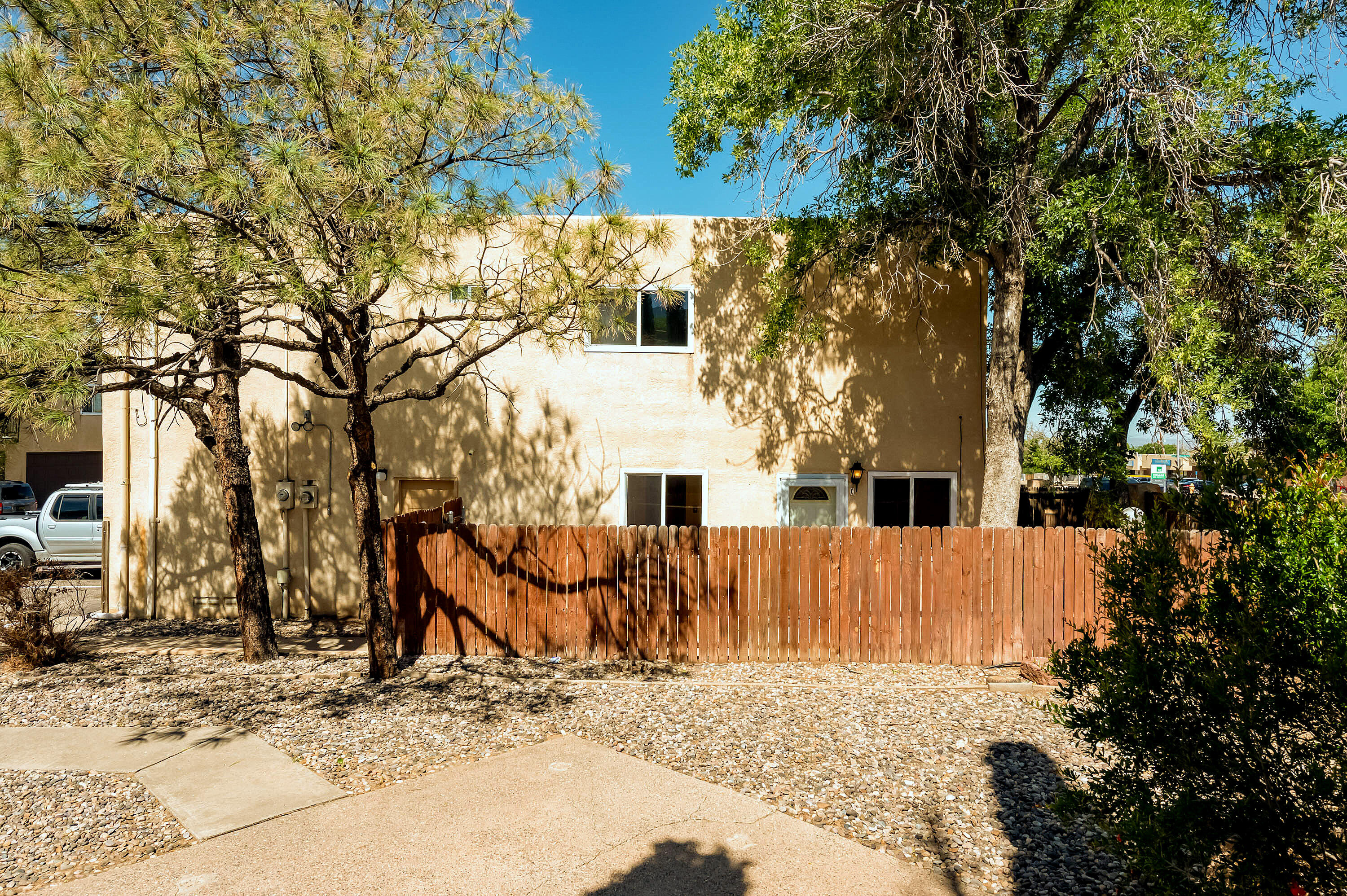 Enjoy mountain views in every direction from this well-located 2-bedroom, 1-bath condo! One bedroom offers stunning views of the Sandias, while every window captures the beauty of the Manzanos--and from the backyard, take in the Jemez Mountains. With the largest and most private yard available in the community, this home is perfect for relaxing or entertaining. Fresh paint, young flooring, and a convenient floorplan make it move-in ready. Just minutes from trails, parks, shopping, and restaurants. Quick access to I-40, Sandia Labs, Kirtland AFB, UNM, and a straight shot up Tramway to Santa Fe. A rare blend of privacy, convenience, and natural beauty!