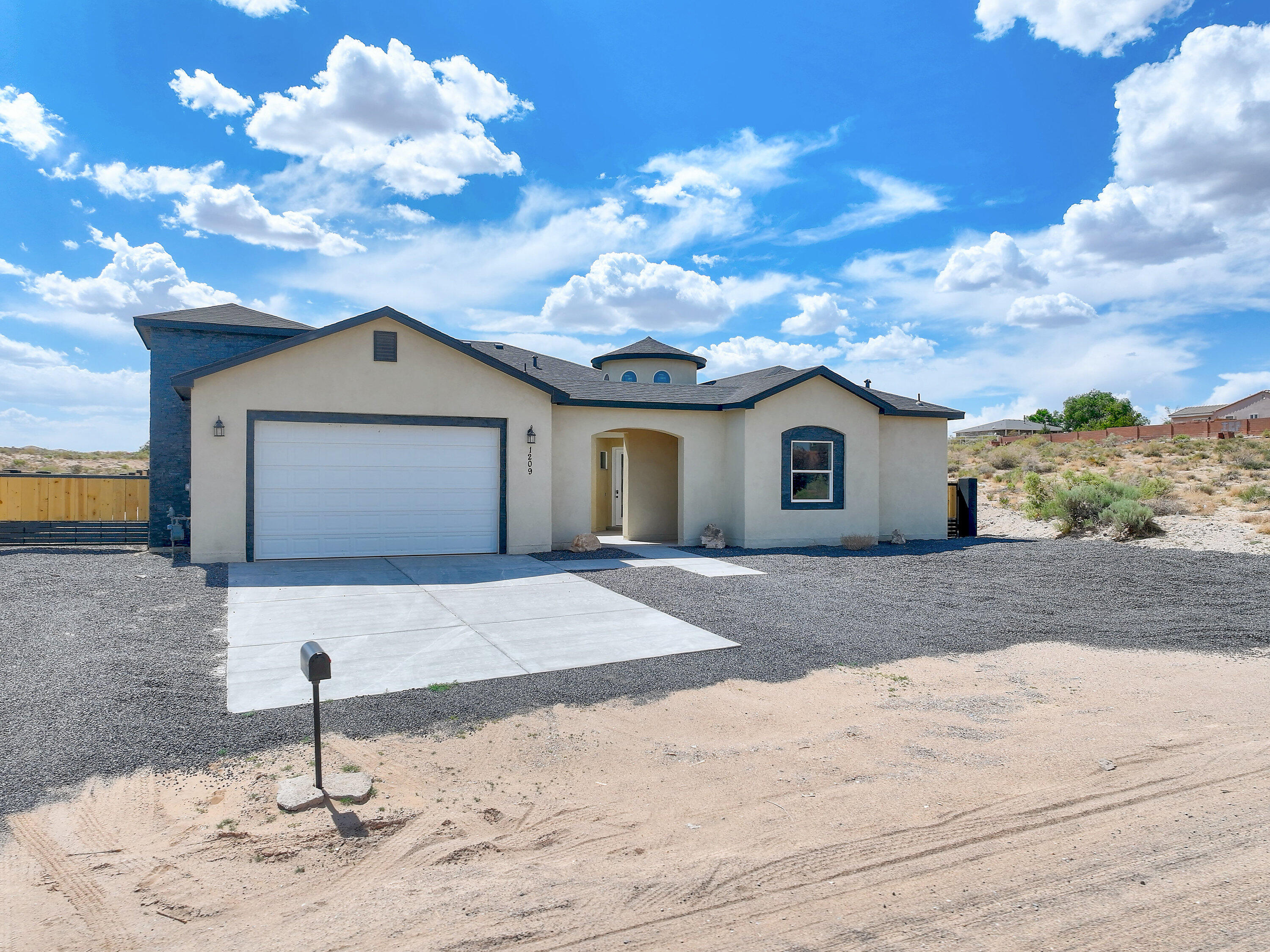 Introducing an exquisite, custom new build masterpiece in the vibrant community of Rio Rancho, where modern luxury meets timeless elegance. This luxurious, single-story residence spans an impressive 2802 square feet, with four spacious bedrooms and four bathrooms designed for comfort. Situated on a sprawling half-acre lot. As you approach the main entrance, a stunning courtyard welcomes you home to a 17 foot ceiling tower and the open concept design seamlessly connects the kitchen to the living and dining area enhanced by a modern recessed ceiling and custom tile flooring creating  an inviting space for gatherings. Enjoy 10 foot ceilings throughout the home.