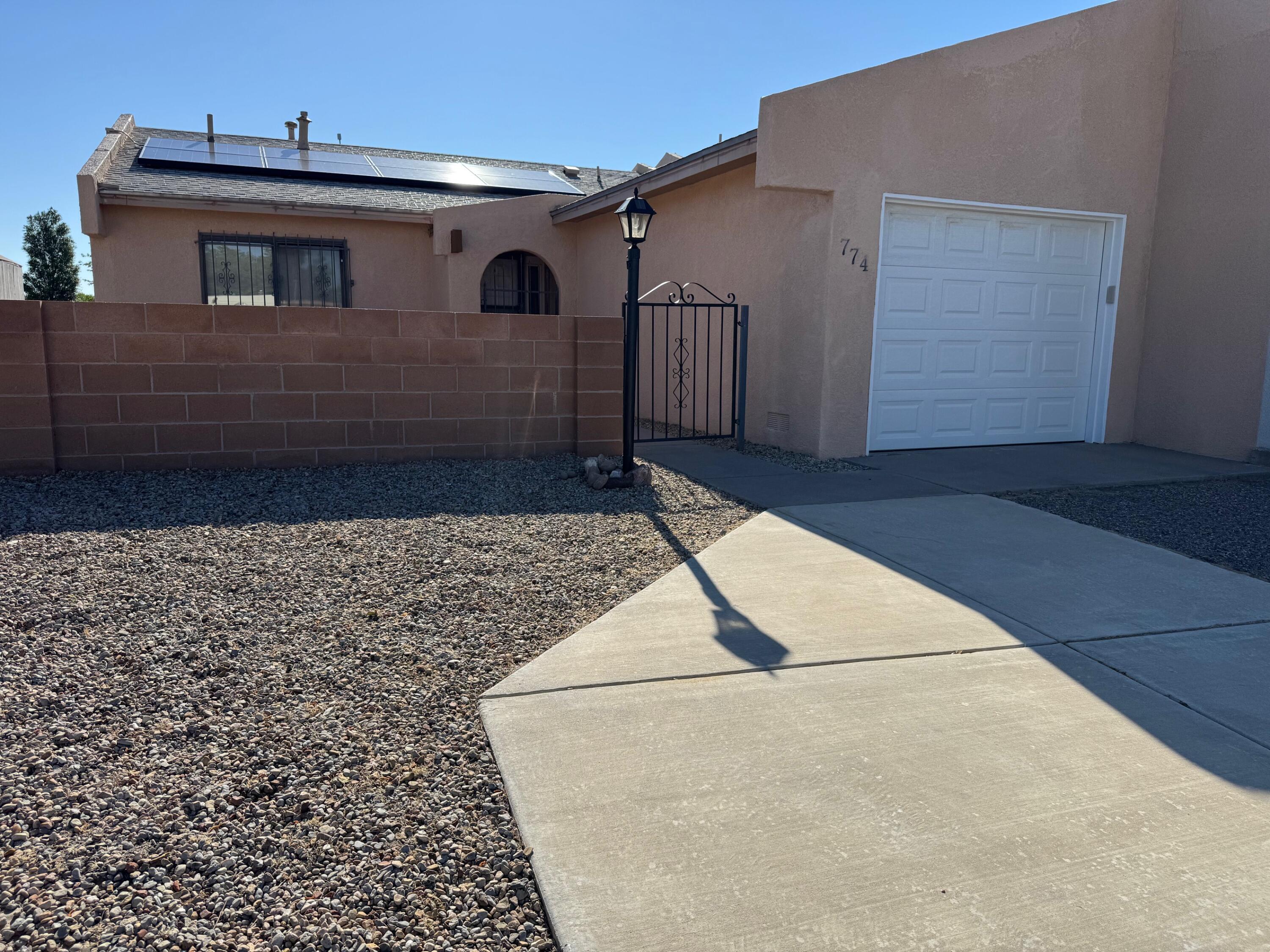 Nicely updated home located in the heart of things to do in Rio Rancho like shopping, restaurants, parks, employment and much more. Updated kitchen with granite countertops and pull-out cabinets and kitchen pantry. Full bathroom. Spacious living room and Kitchen. Solar that's paid off and refrigerated air conditioning! Living room pours out on to the patio in the backyard with views. Great for entertaining! Walled front courtyard.  Save money on move in because all appliances stay.