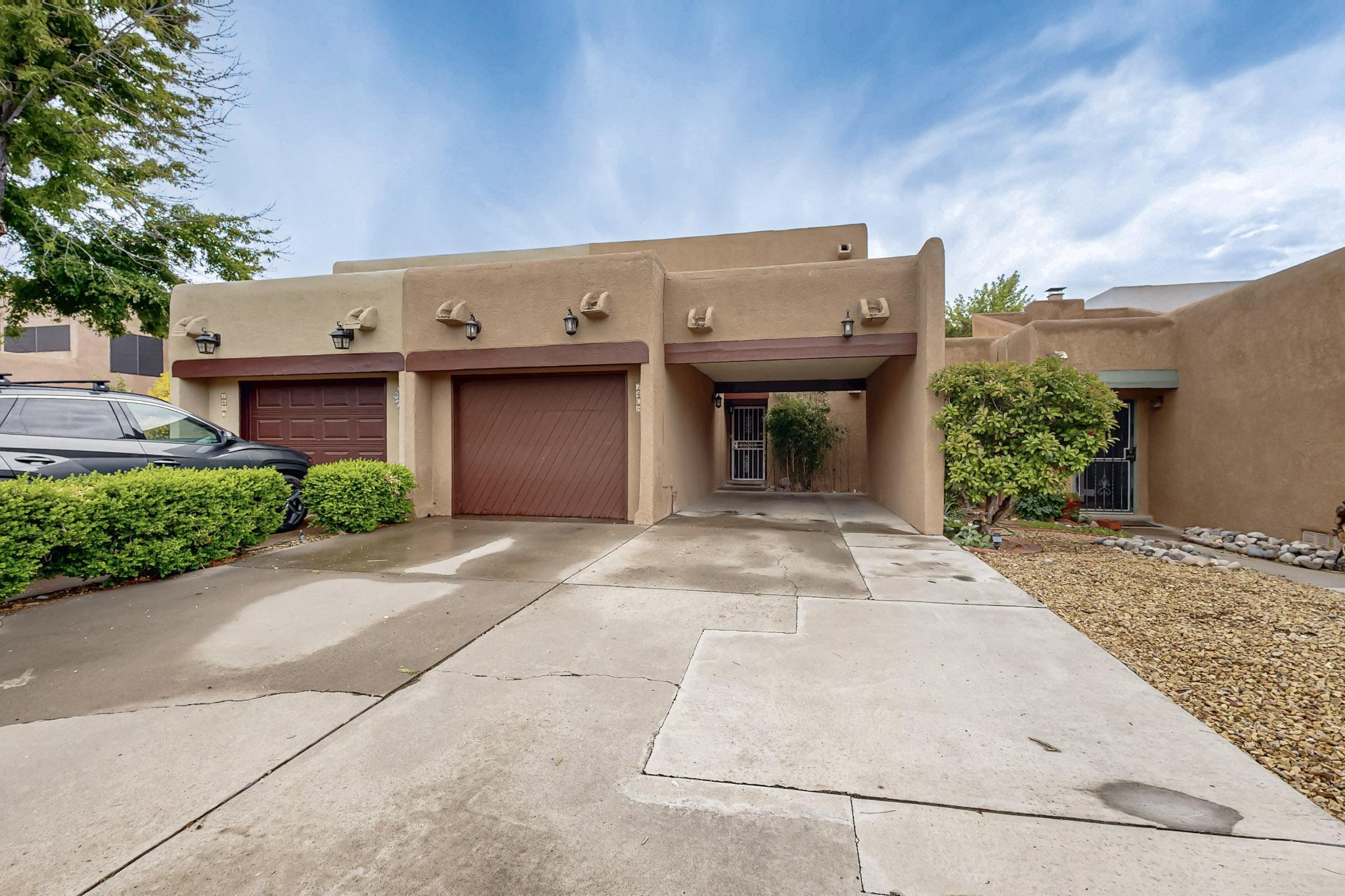 Well maintained Northeast Heights townhome on a low traffic street. 3 bedrooms with 2 & 1/2 baths. Great light from multiple skylights. Blocks to Arroyo Del Oso golf course and shopping. Low maintenance front yard and mature landscaping in the back.  Bathrooms have beautiful classic Talavera tiles and sinks. House has understated southwestern style with vigas and fireplace. TPO roof and recent Mastercool type cooler.  Sit out on the second story deck and enjoy the great views, or spend the afternoon in the shade on the patio below. Come see 7408 Lantern today. Property is in an optional HOA.