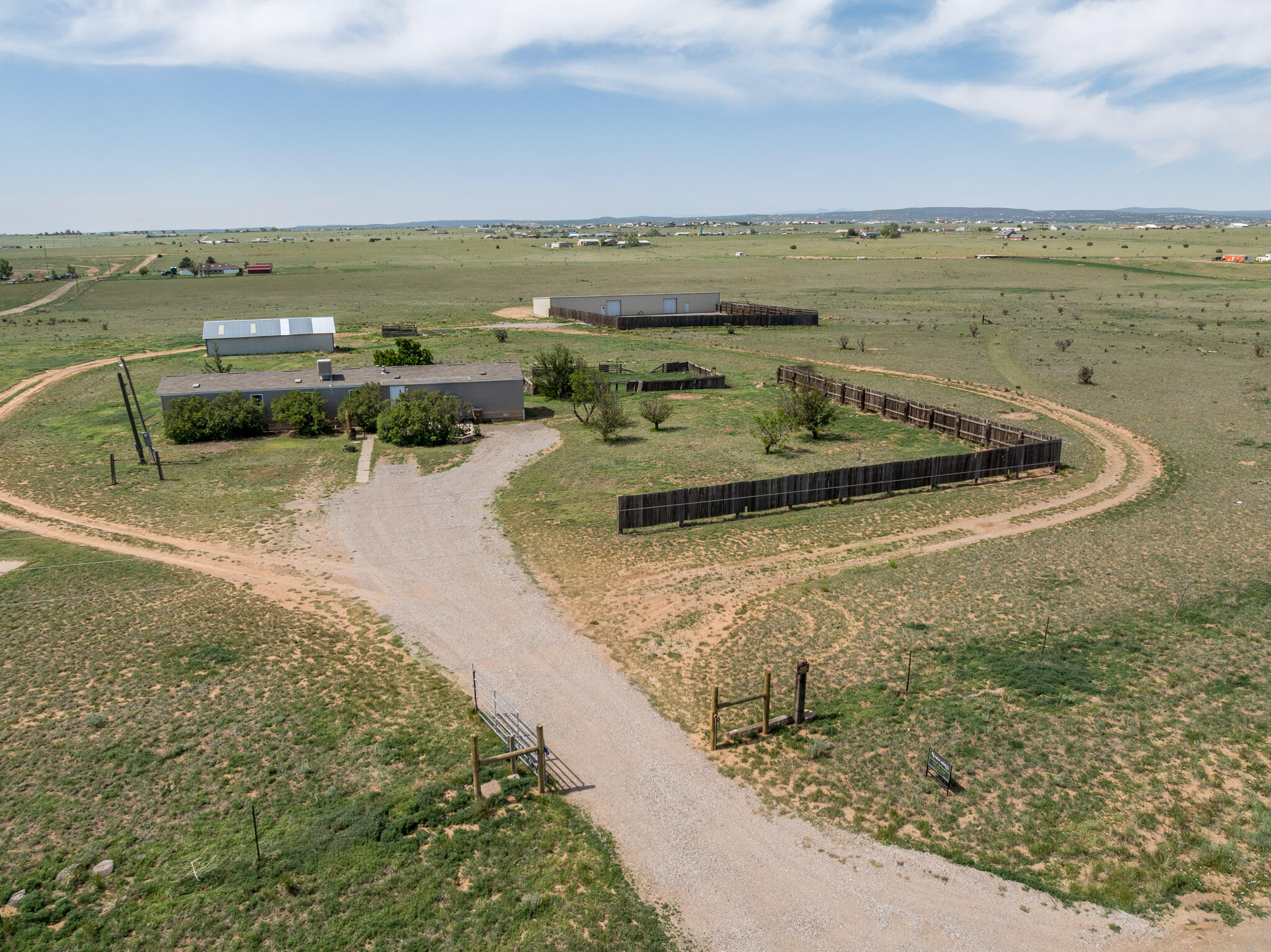 RARE FIND with endless opportunities on this peaceful Edgewood property on 20 ACRES with a 4800 SF METAL BUILDING and BARN! Dreaming of a hobby farm, family compound, workshop or car/toy/equipment storage, or split the lot and rent or sell part or maybe convert the building to a Barndominimum! Nice 2012Clayton manufactured home is super clean and move in ready.  Split floorplan with a spacious primary ensuite with huge soaking tub & separate shower.  Several fenced areas and trees surround the home including mature lilac in the front of the property.  There is buried rough-in electric from the house to the barn, and barn to the shop.  Buyer to complete their due diligence on the electric hookup and zoning for desired use. Peaceful and quiet area of Edgewood, yet many conveniences nearby.