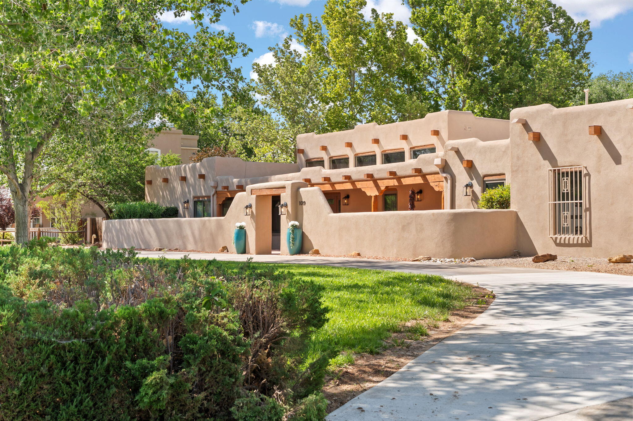 Grande Open House June 7 & 8, 1-3 pm. Exquisitely Renovated, Rio Grande Estates Coveted Green Belt Location. NEW Chef's Kitchen, quartzite counters, 2 Pantries, Vintage Viking 6 Burner, Massive Island and Dining. Tall wood beamed living room ceilings, sunlit clerestory windows. Artisan Hand plastered walls and ceilings; Solid wood 6 Panel Doors. Seamless indoor outdoor flow to Inground gunite pool and portals.  Backyard Mountain Views. Radiant heated Solid White Oak Wood and stone floors. 5 large bedrooms, 3 w/ Ensuites, 2 Owner's Suites, 4 baths, 3 car heated epoxy floor garage. 3 combo units HVAC. Irrigation Well keeps yard green. Poultry Barn, tool shed, fruit trees, garden.Access miles of trails via Open Space nearby. Cottonwood Mall 5 min, Sunport Int'l Airport, Downtown, Base ABQ 25