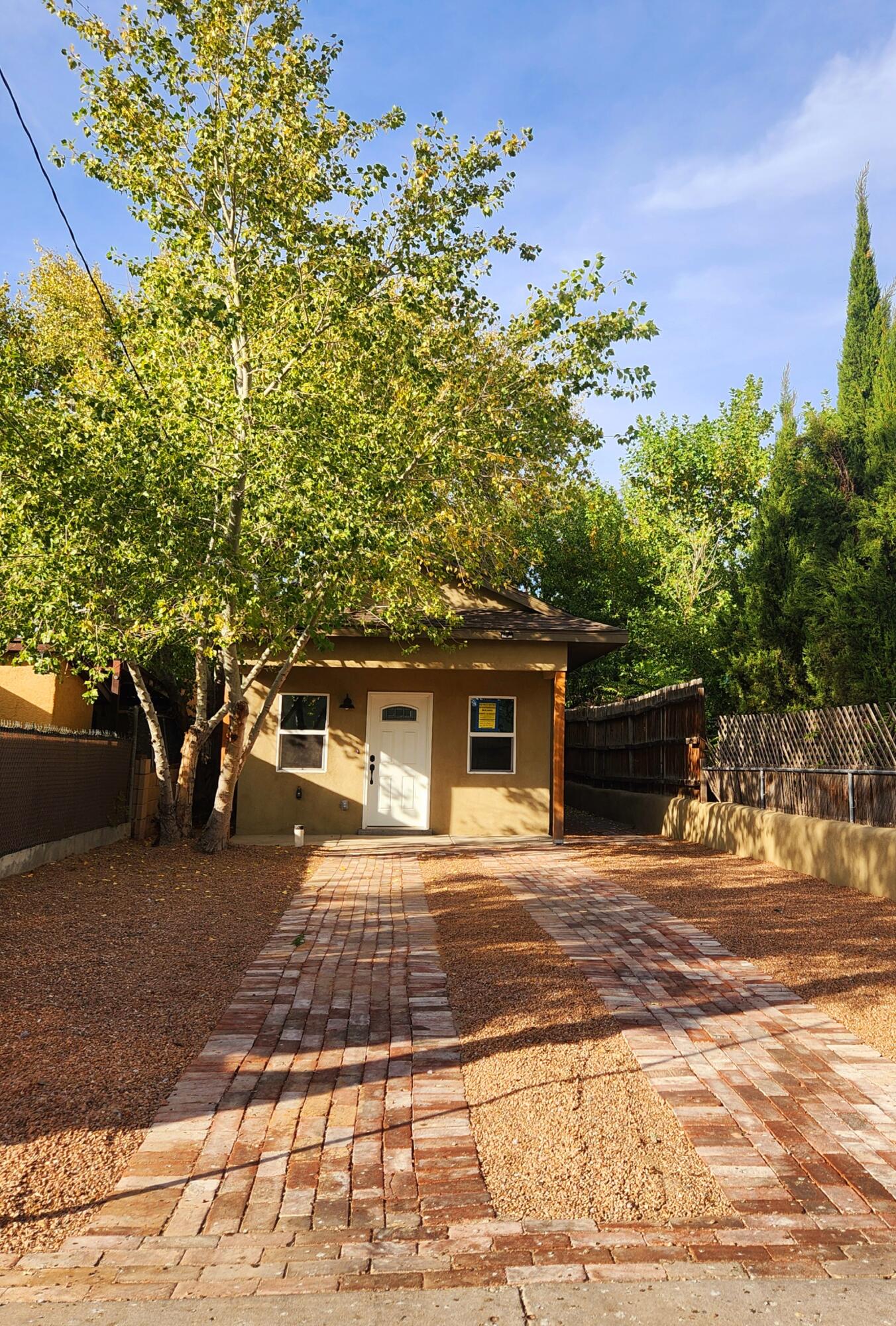 COMPLETELY RENOVATED ADOBE HOME near downtown. Framing, roof, electric, plumbing, HVAC and finishes were all done in the last 6 months. The only original portions of the house are the adobe walls and a plaster coved ceiling. Amenities include additions to the front and back of the house, skylights, plaster walls, granite countertops and new stainless steel appliances. One block from Bosque bike trails, one block from the Hispanic Cultural Center, two minutes from I-25, 7 minutes from the airport and convenient to hospitals. Amenities include the original coved plaster ceiling, new granite counter tops, new plumbing, new electric, new skylights, new HVAC, new roof, and trusses.