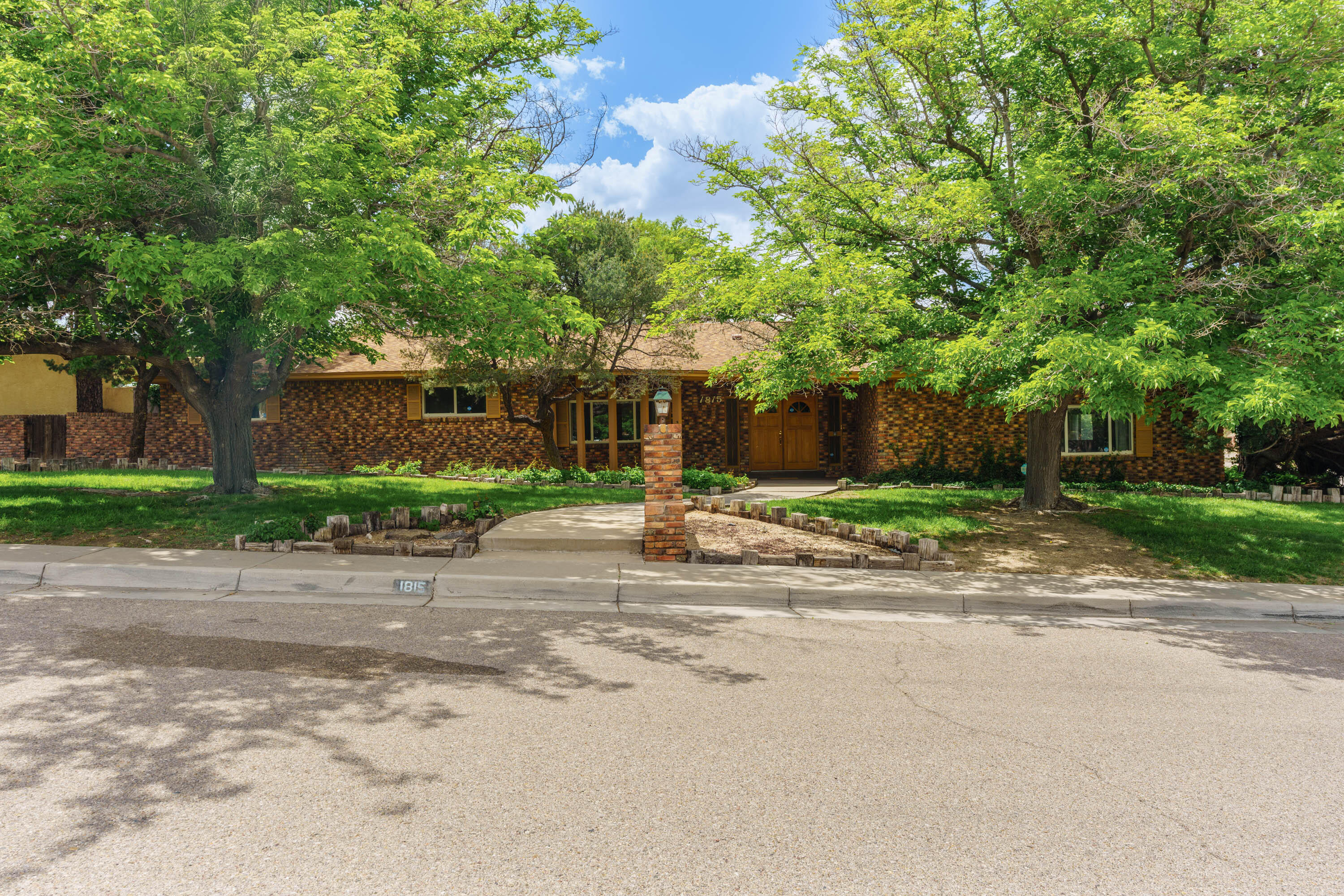 Distinguished mid-century one-story ranch style custom brick home on large lot close to Netherwood Park. Double-door entryway/foyer welcomes you into this 5-bedroom home with 4 bathrooms (2 full bath, 1 3/4 bath, and 1 1/2 bath) with primary bedroom separate from other bedrooms. 3 car garage.  Large landscaped corner lot with many mature trees. Unique features include custom music stage and flagstone floors in living areas. Large walled backyard with open patio and custom outdoor fireplace/cooking area.