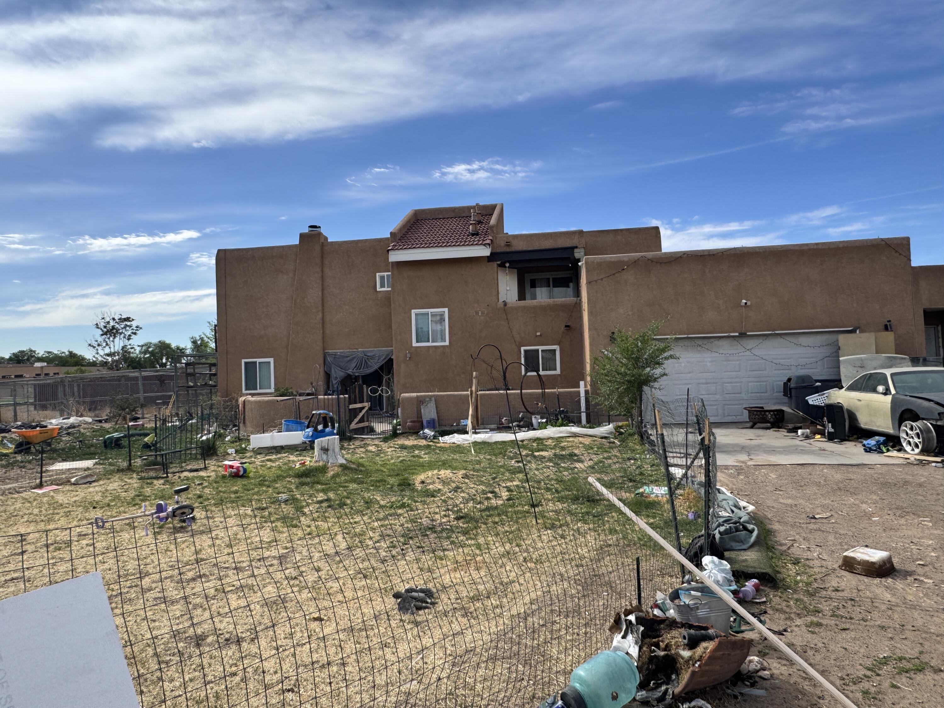 Investor or Remodel Special! Massive potential for this multifamily home that boasts 2 living areas, 2 kitchens, 3 bed/3bath located in the North Valley on .68 acre lot with attached 1 bed/1bath casita and 2 car garage. Gated on private drive. Home is sold as is. Gas and electric meters have been removed please see property disclosure. Home and casita have tested positive for meth and fentanyl use. No evidence of a lab has been found. Functionality of appliances, hvac systems, evap coolers, and fixtures is unknown due to no gas or electric. Water supply is good and meter intact.