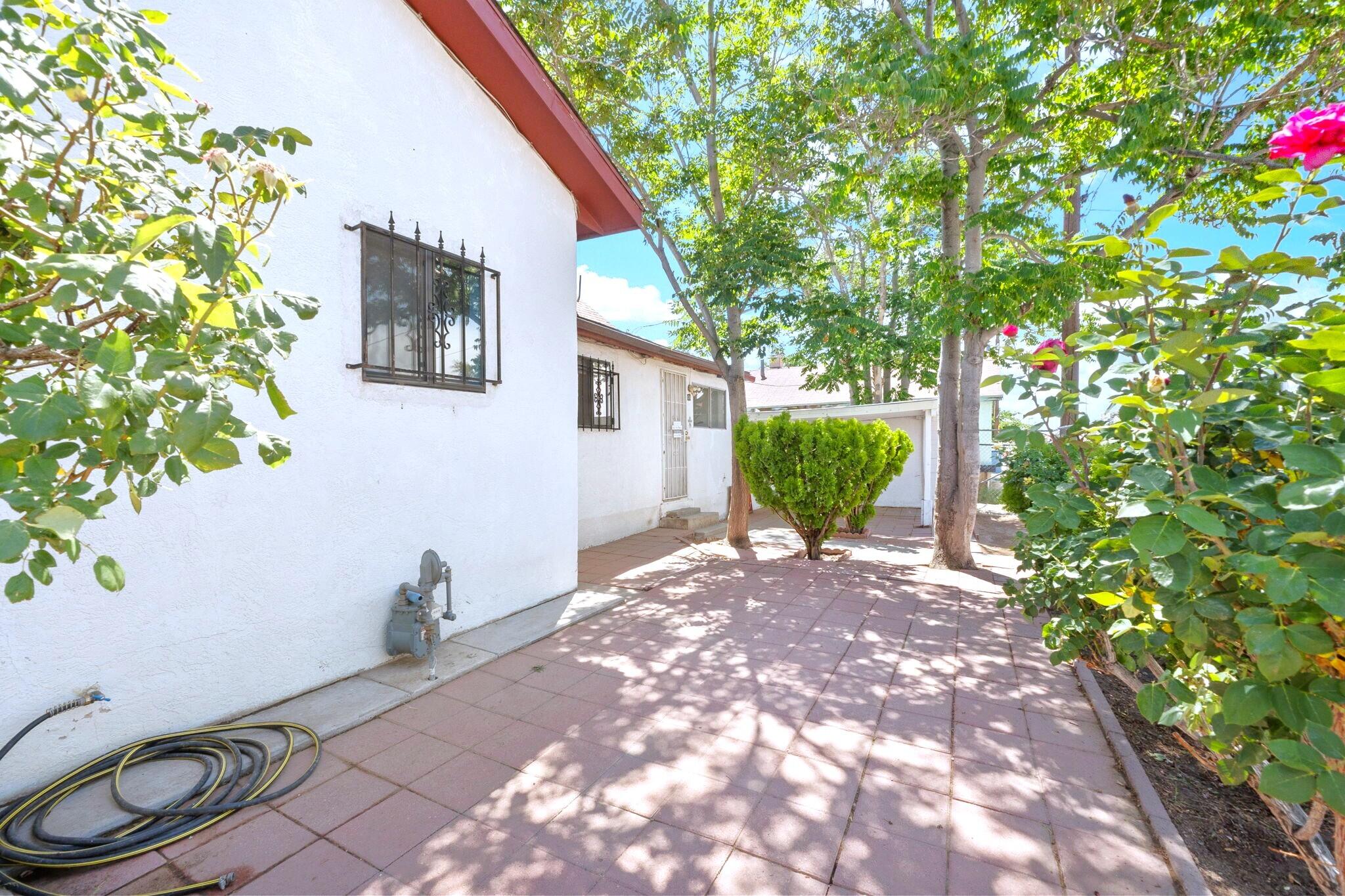 If you're on the search for a home with coveted Oldtown amenities, then search no more! This beautiful 2-bed 2-bath home  is only 2.5 miles from Sawmill Market, 1.5 miles from Lowe's Home Improvement, only 1 mile from Rio Bravo Brewing Company and Tractor Brewing Company. Enjoy the nearby Natural History and Science Museum & Explora with nearby restaurants such as Cocina Azul and Antiquity Restaurant. This charming home has a beautiful brick patio with blooming rose bushes and large trees perfect for shade while spending time in the front yard. Enjoy the large living area ideal for entertaining guests. The quaint kitchen has an extended loft ideal as a dining area. With backyard access, there is ample space to park vehicles or an RV under the carport area. Schedule your showing today